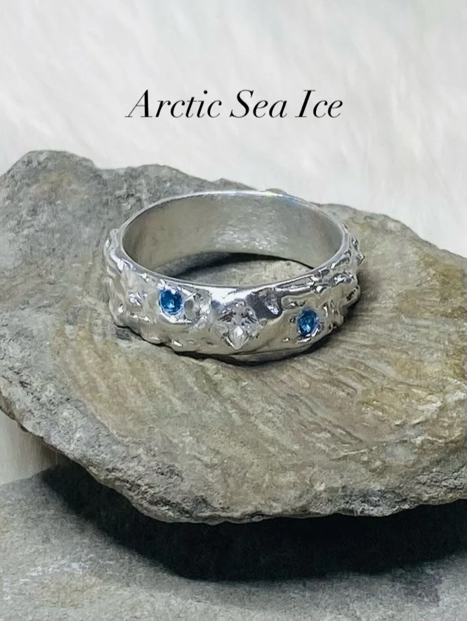 Welcome to Ring #3 of Rings of the North ❄️

Inspired by the quiet beauty and solitude of Canada&rsquo;s precious sea ice, this piece is handcrafted in pure silver and set with a square cubic zirconia, accented by two 2mm round blue cubic zirconias&m