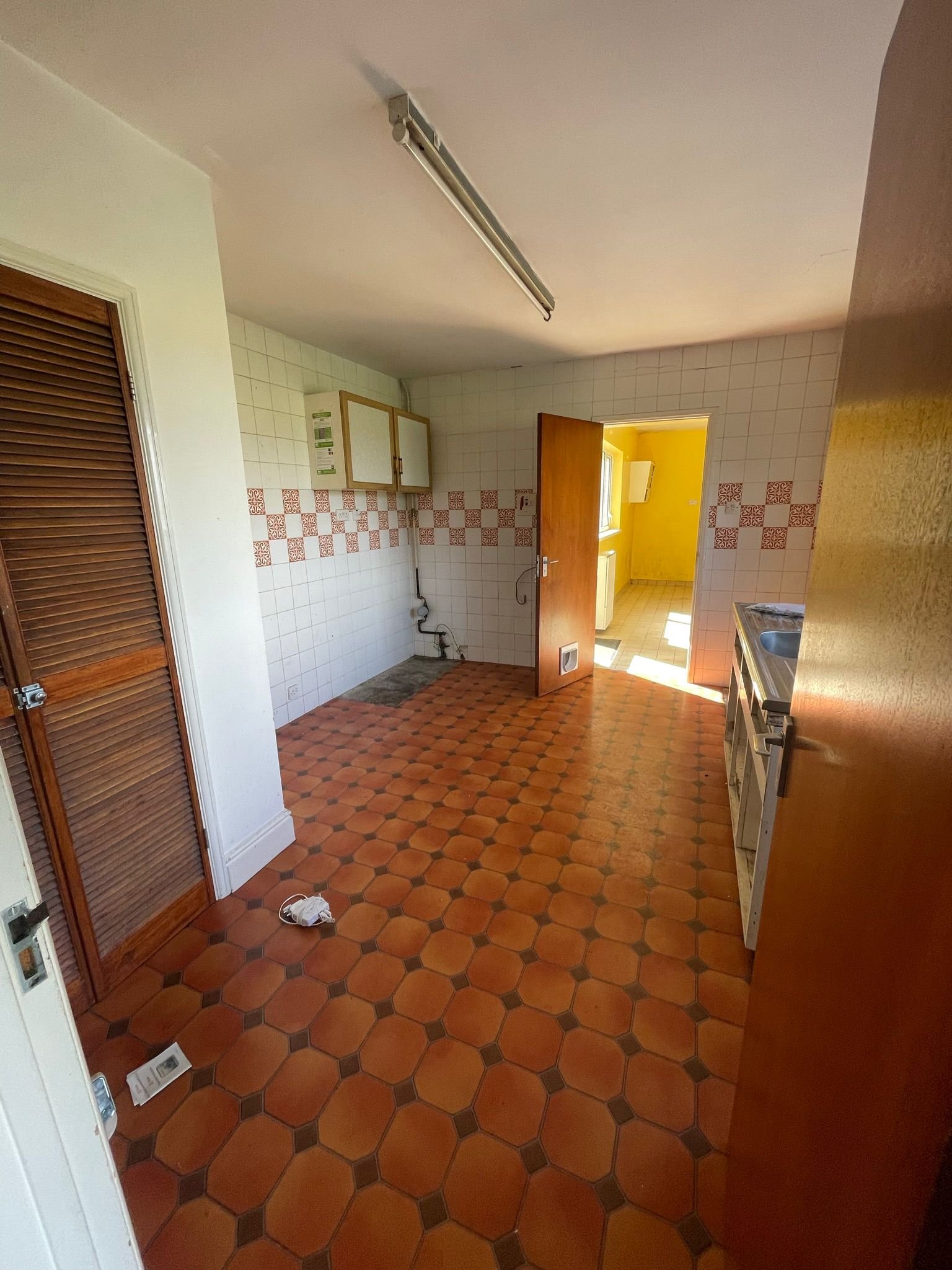 Before: the kitchen that doesn't have any kitchen units in it. Makes for an exciting time cooking meals before the redevelopment starts.