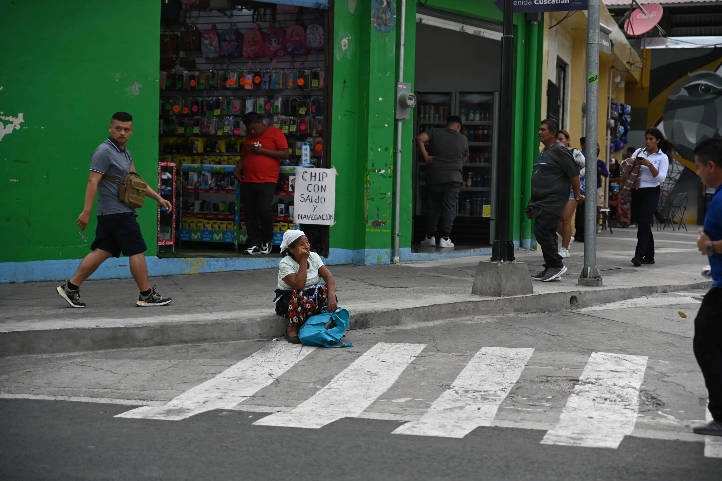 El Salvador streets with woman sitting on ground