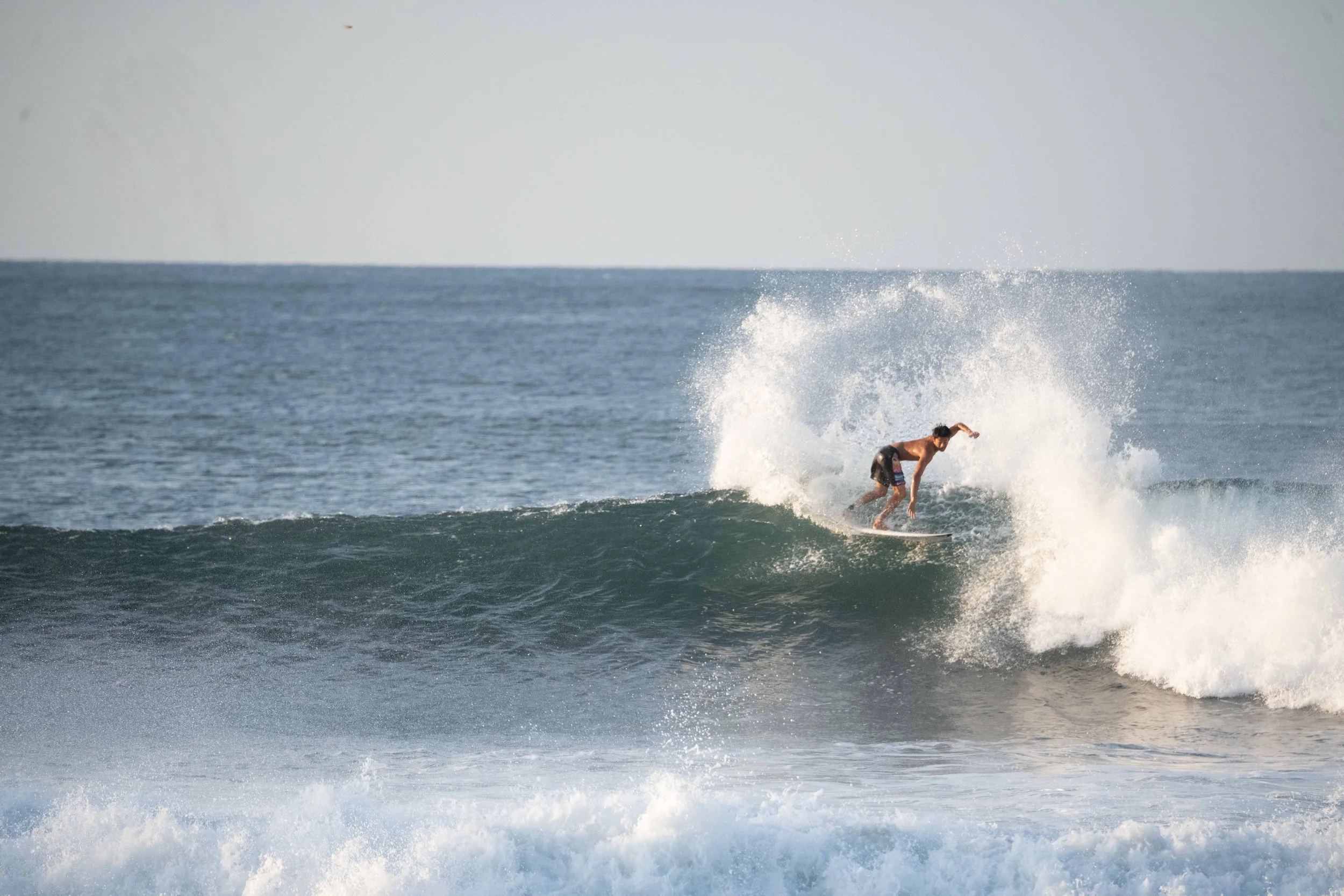 young man riding a wave
