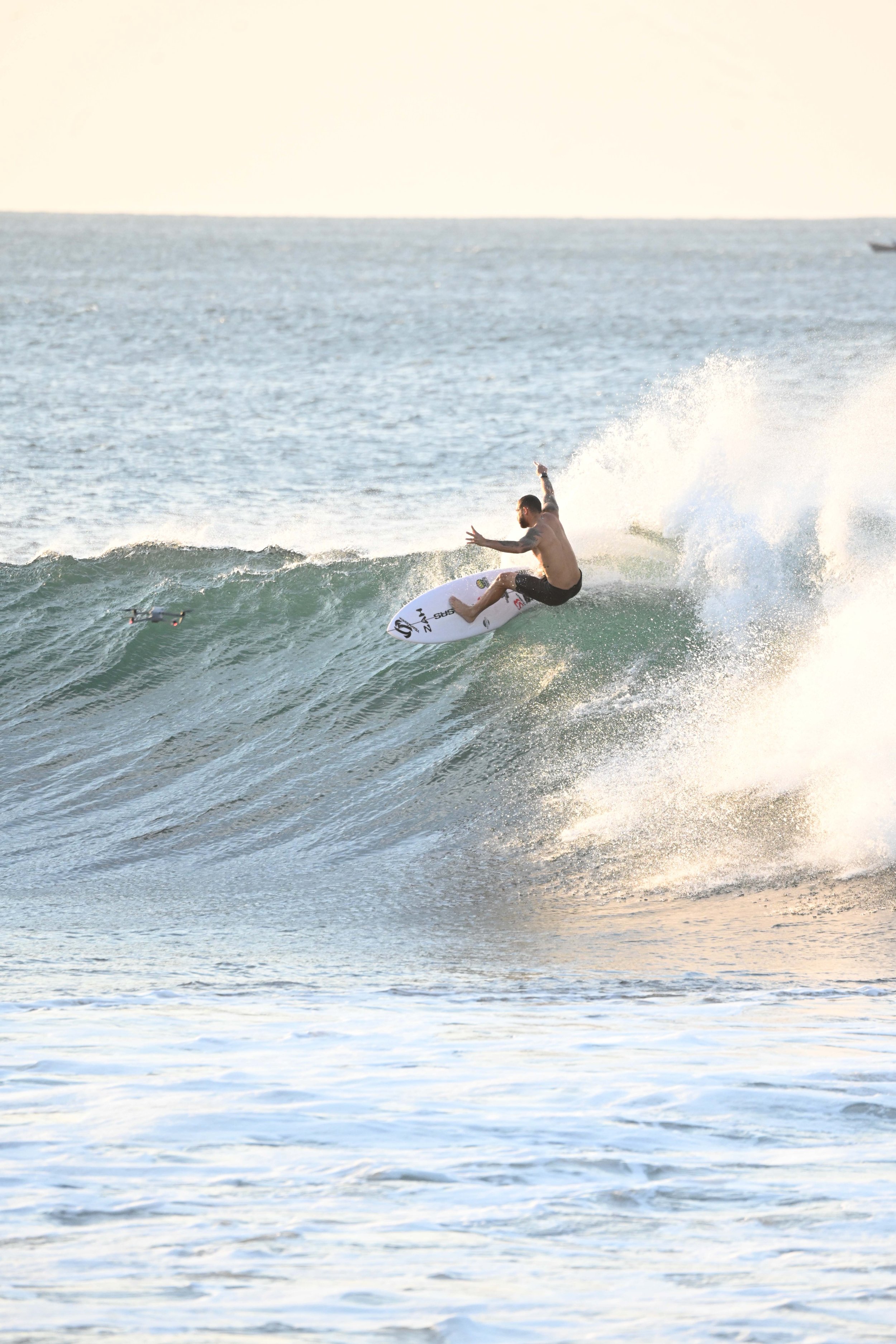man surfing with arms up