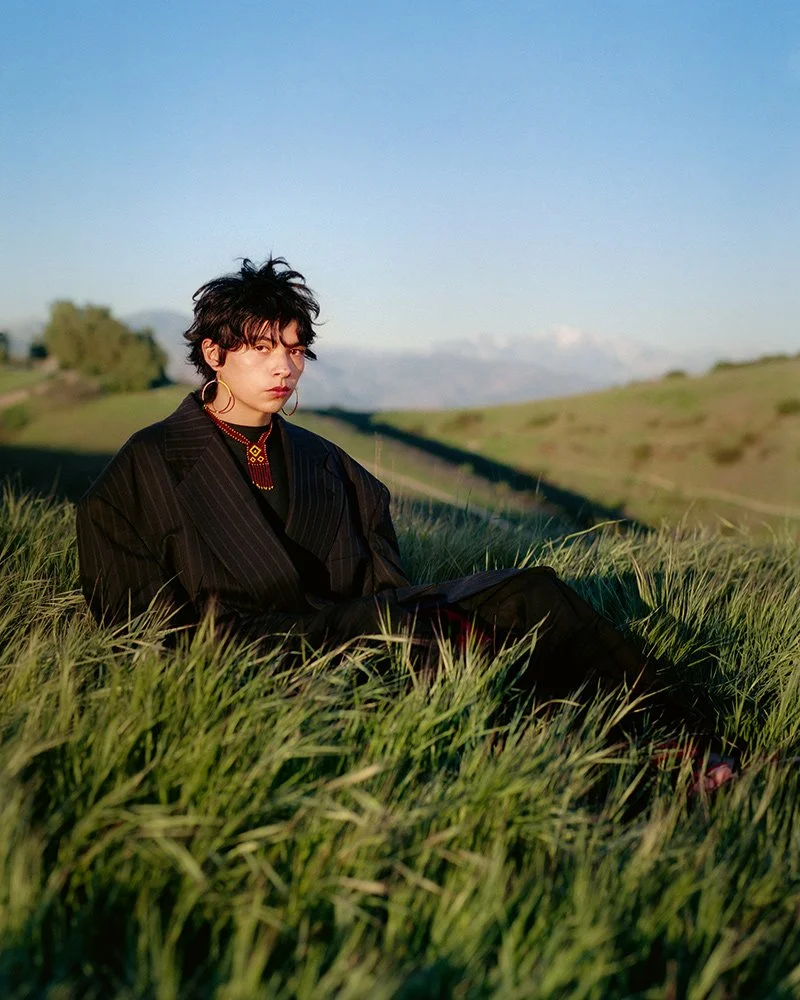 Atlakatl Ce Tochtli Orozco sitting in the fields of Los Angeles