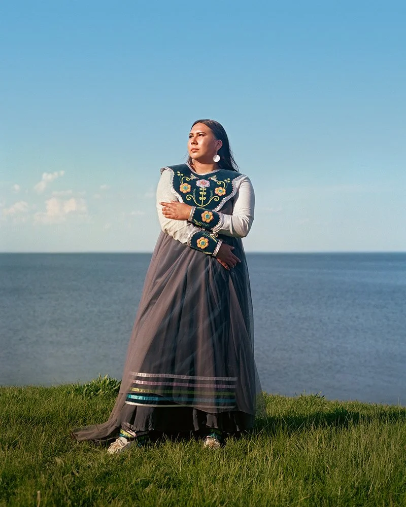 Makaśa Looking Horse staning on edge of lake in Six Nations, Canada