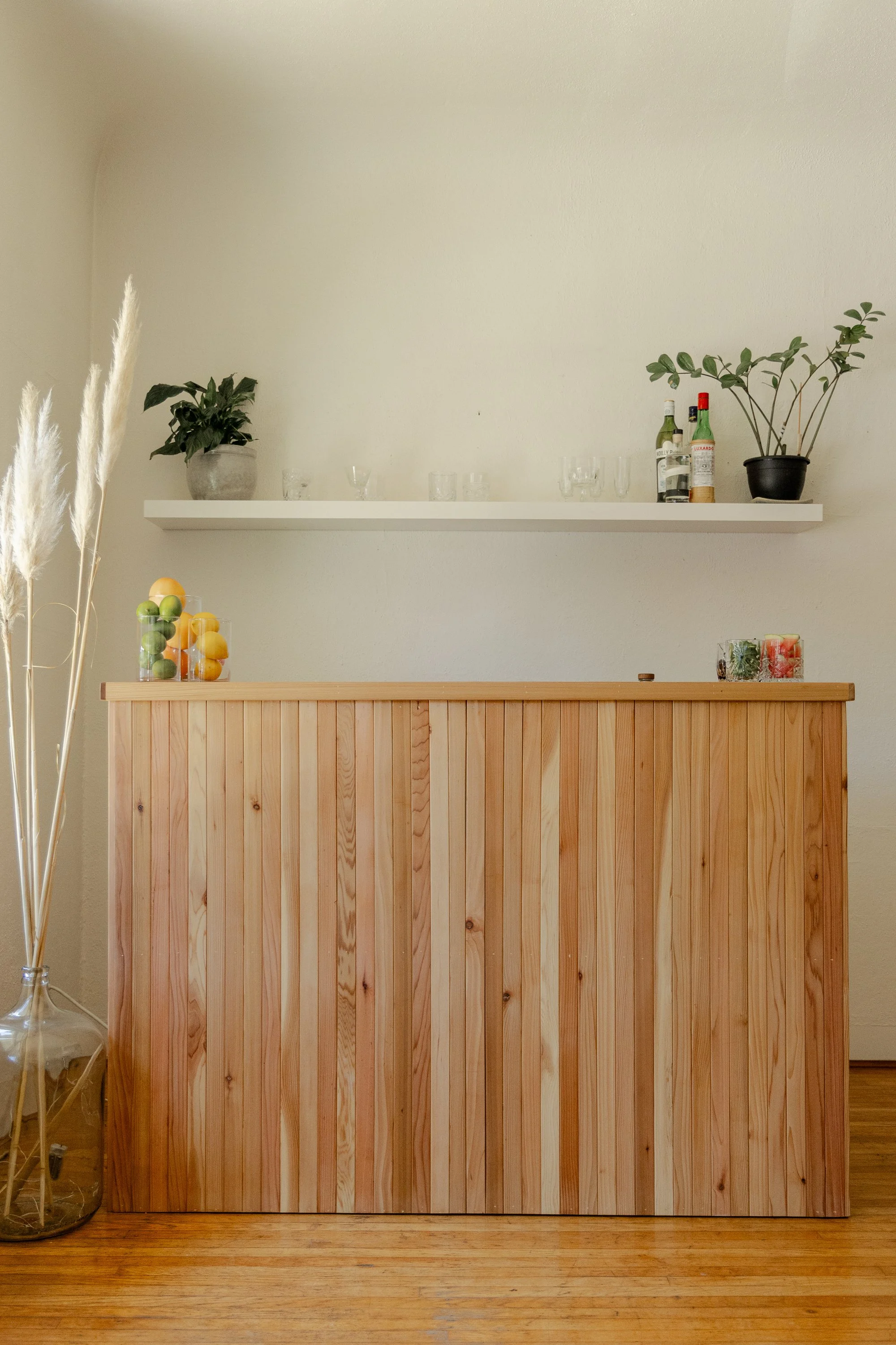 Cedar mobile bar setup for an indoor wedding in Victoria, BC, with fresh citrus and craft cocktail service.