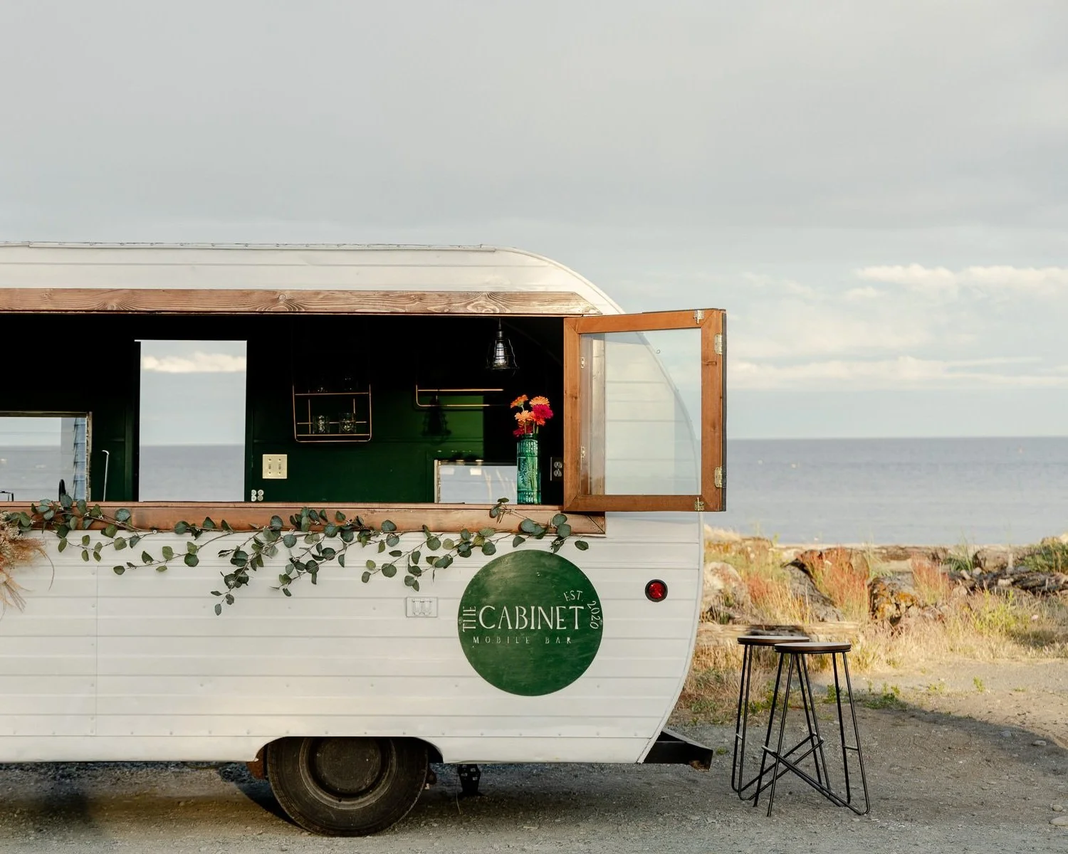 1963 vintage trailer bar rental for weddings and events on Vancouver Island, styled with florals.