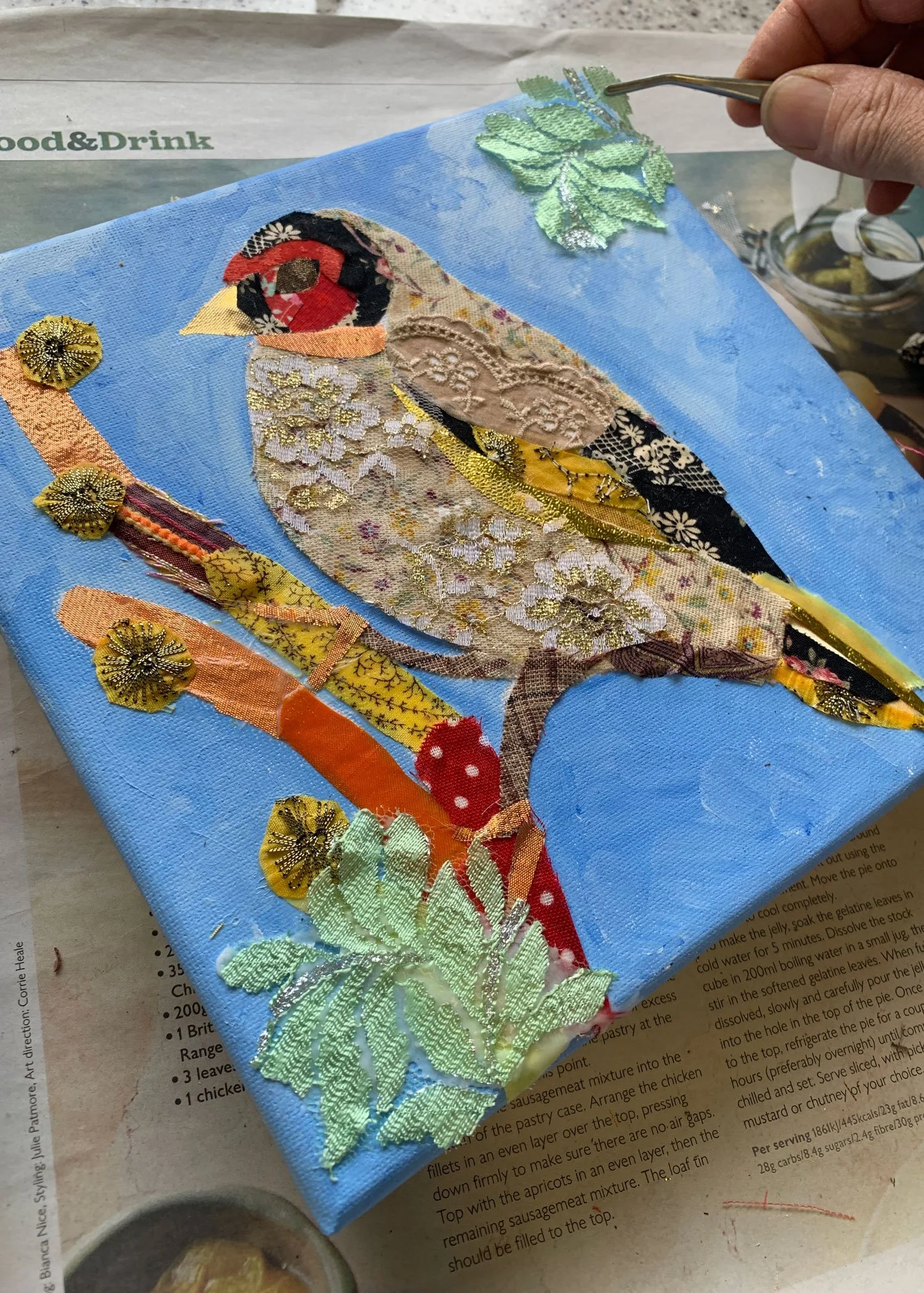 yoshie allan's art workshop image - one of attendee's artwork of fabric collage bird.
