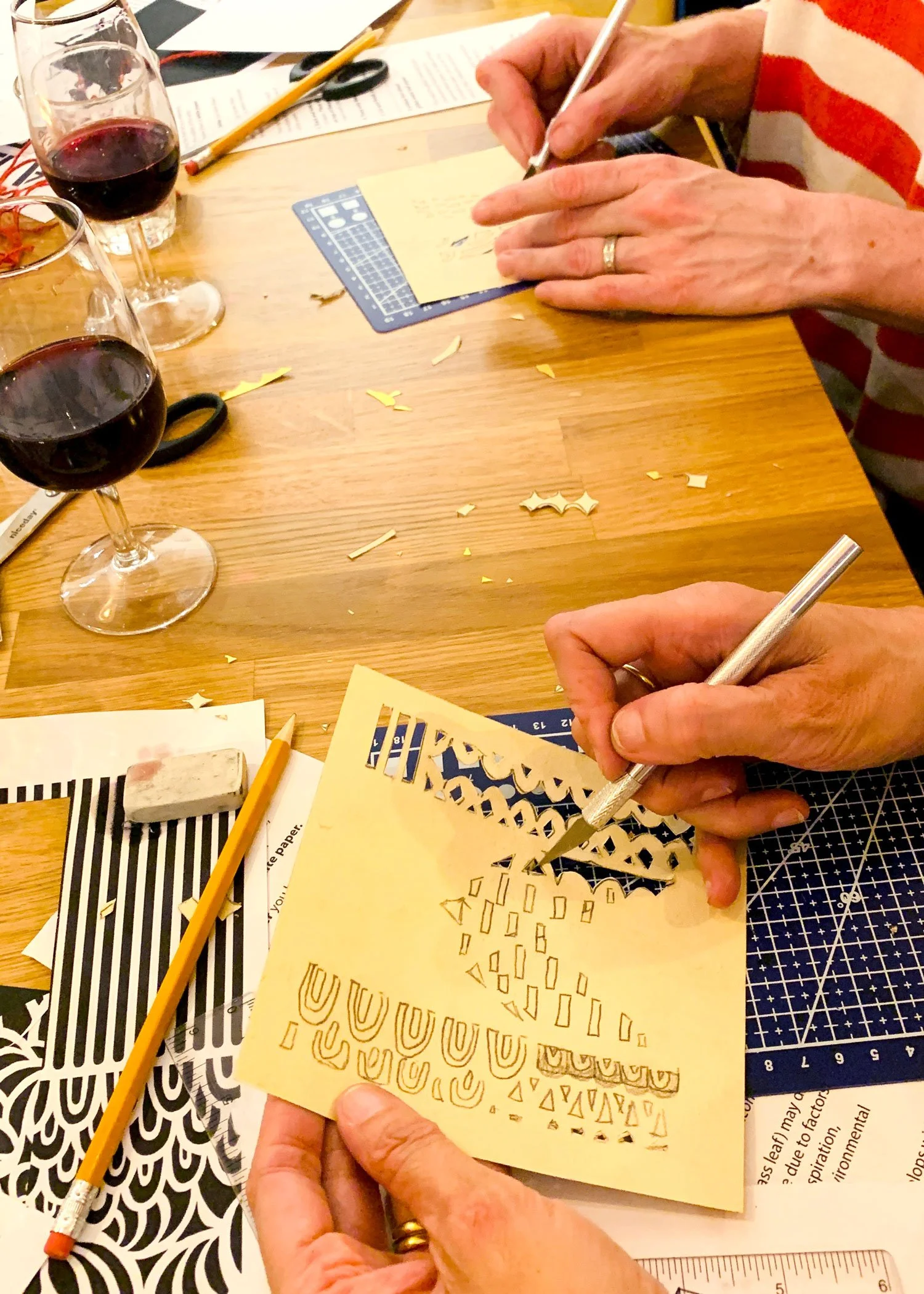 yoshie allan's art workshop image - attendee's artwork in progress at wine and papercutting session at The Wee Vinoteca, Hitchin Hertfordshire UK.