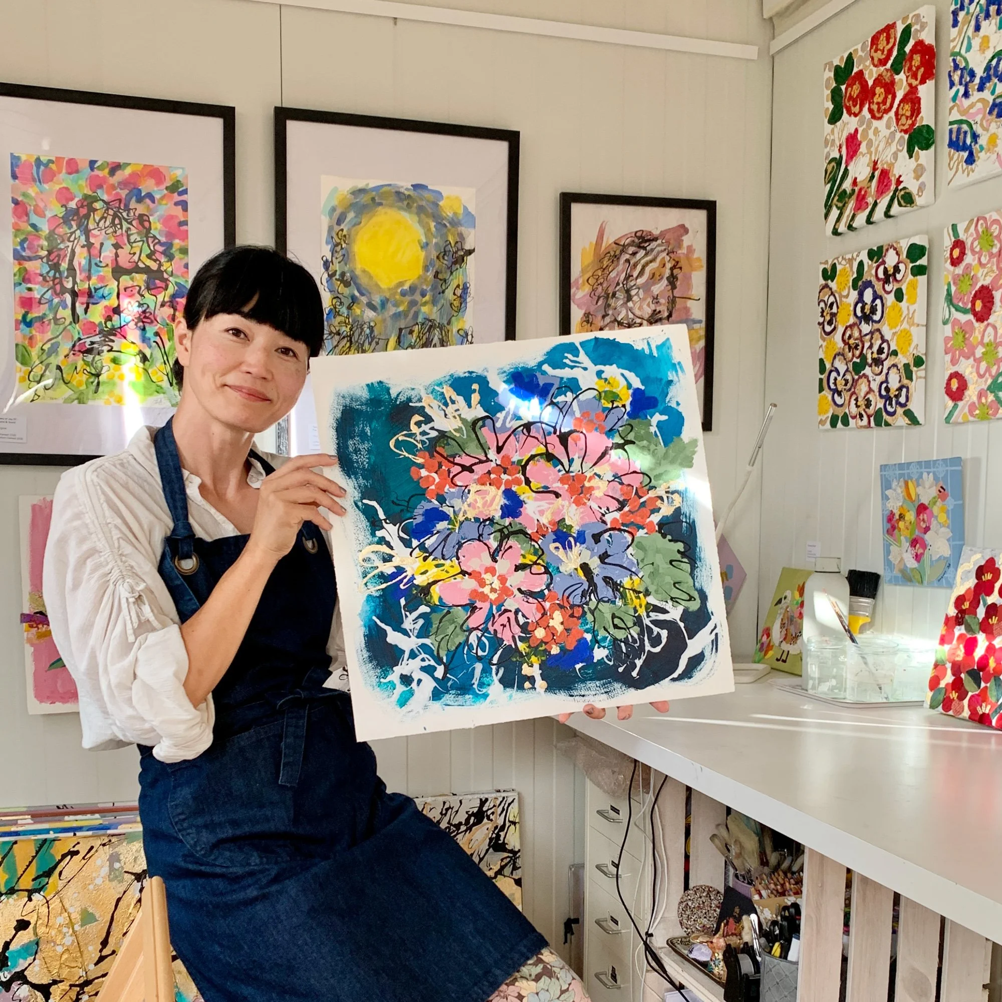artist in studio yoshie allan with her artwork