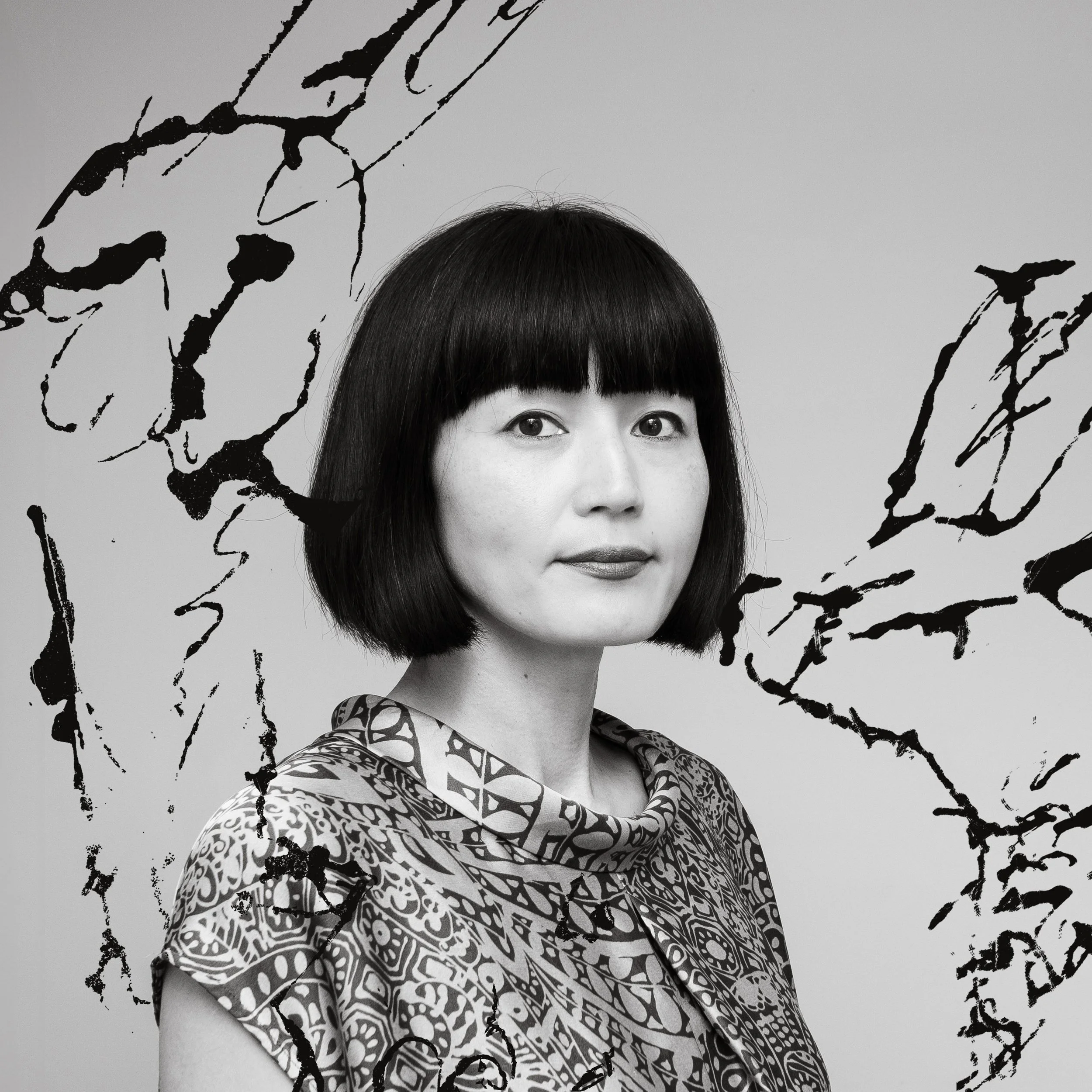 visual artist Yoshie Allan portfolio photo with her ink splash artwork behind.