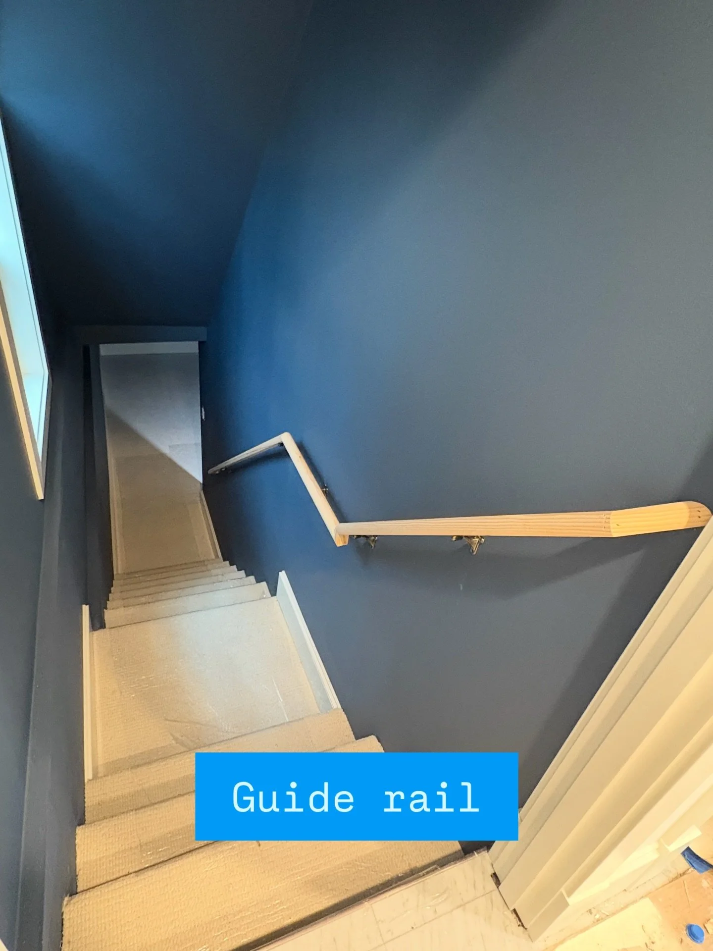 A meandering handrail following the profile of the stair steps