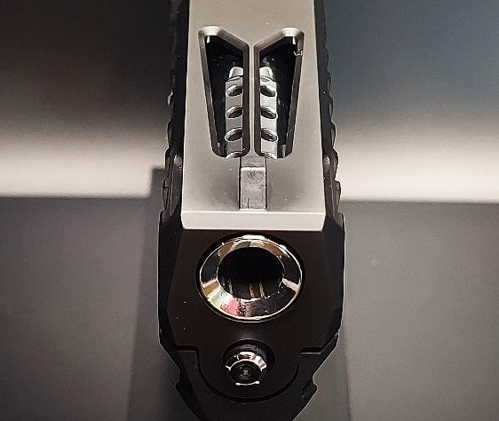 Top view of a tactical flashlight with a crenelated bezel and a textured body.