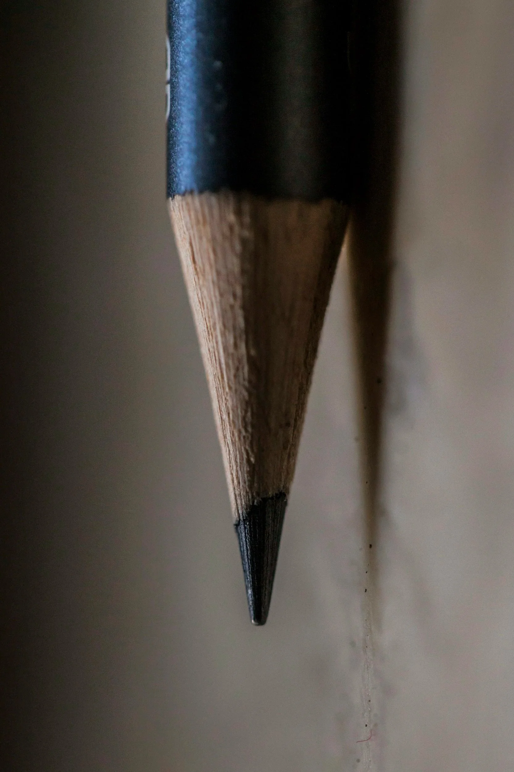 Close-up of the tip of a sharpened black pencil.