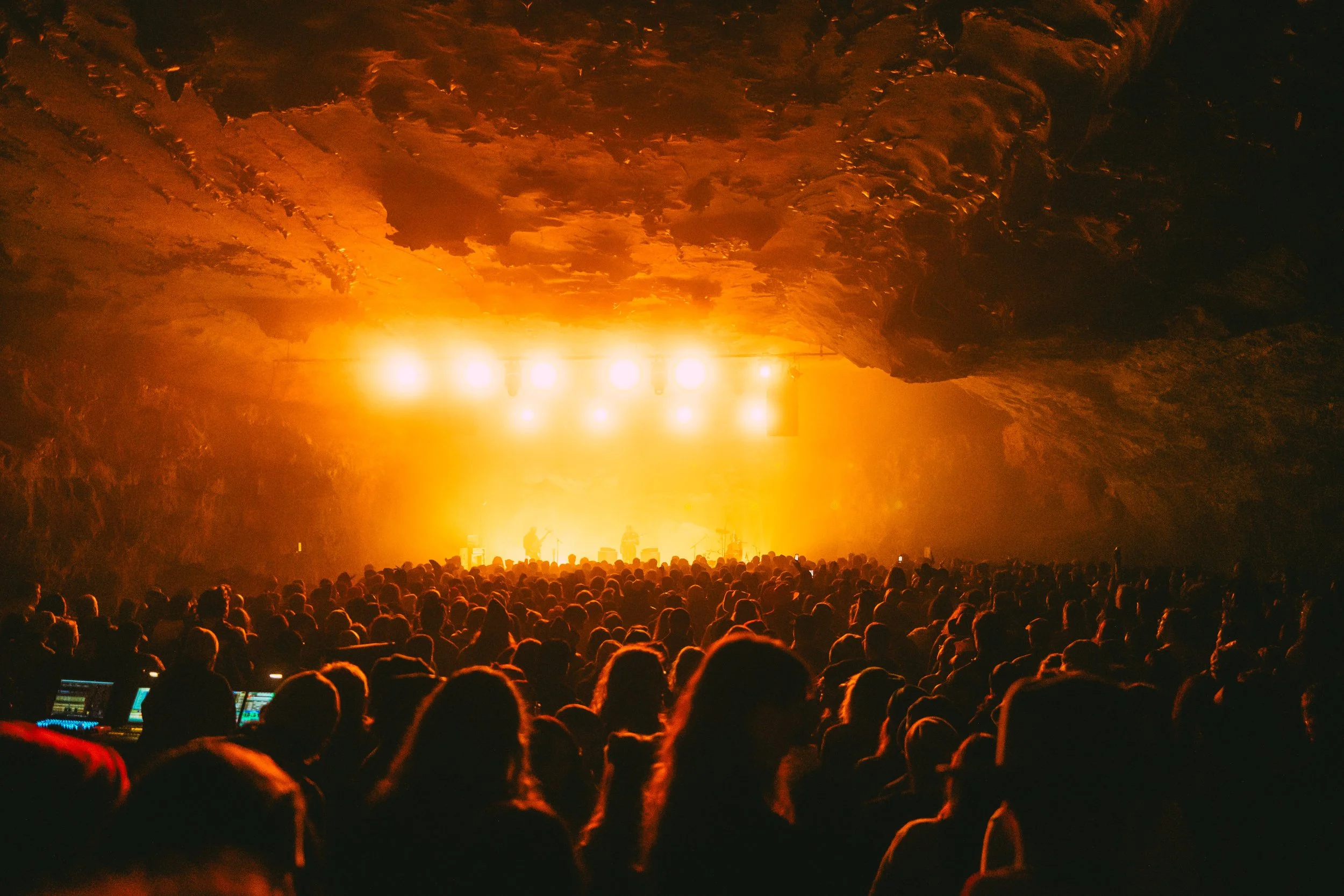 A large crowd watching a concert inside Bigroom Cave at The Caverns in Pelham, TN.