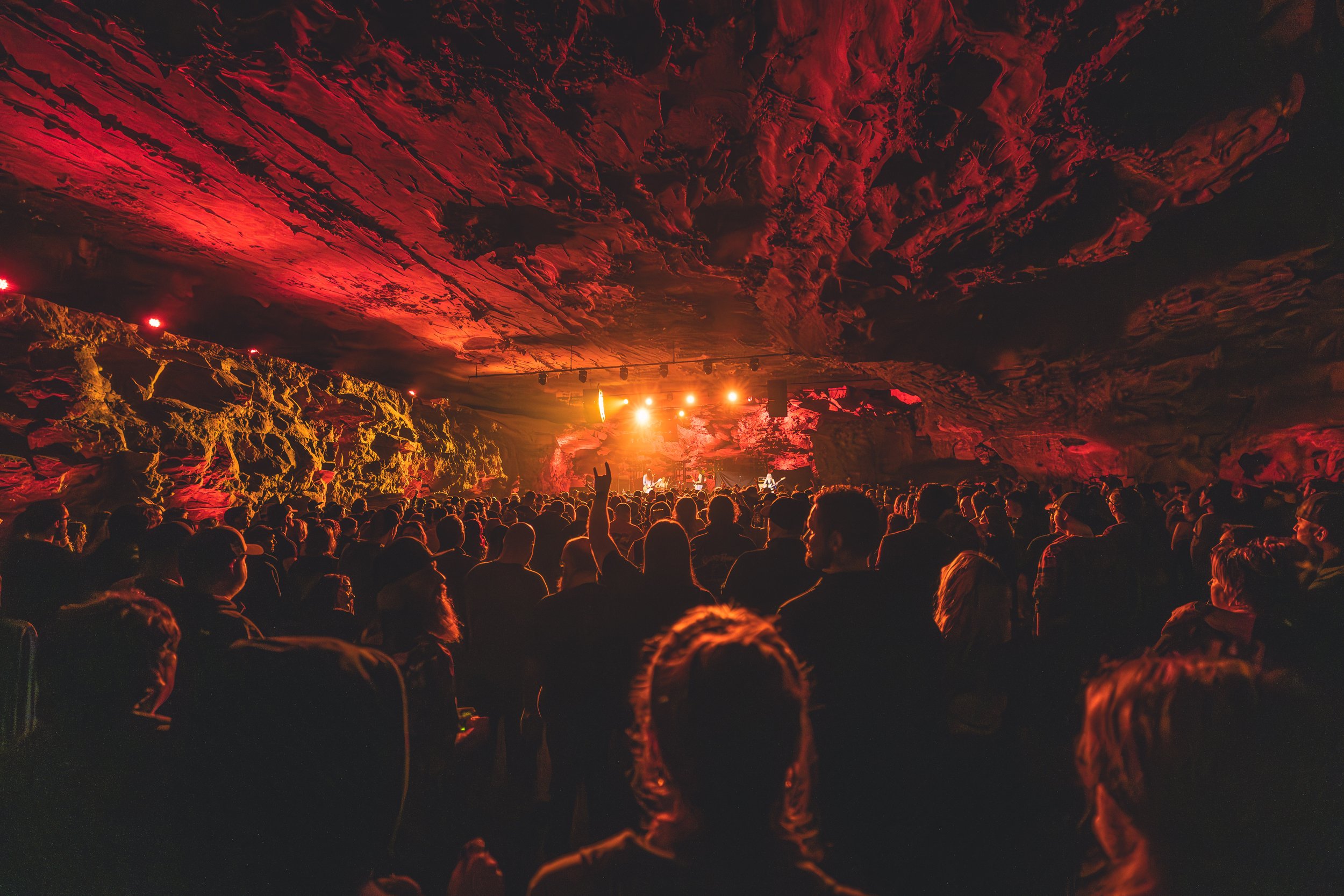 A crowd of people attending a live concert in The Caverns.