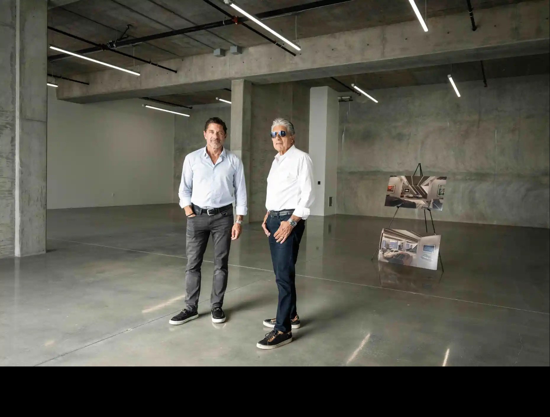  Tony Principe and his father Tony, the father-and-son duo behind Finish Line Auto Club, pose in Tony’s garage condo with plans for how he is going to build it out at the Calabasas development for car enthusiasts on Tuesday, Oct. 21, 2025. The compan