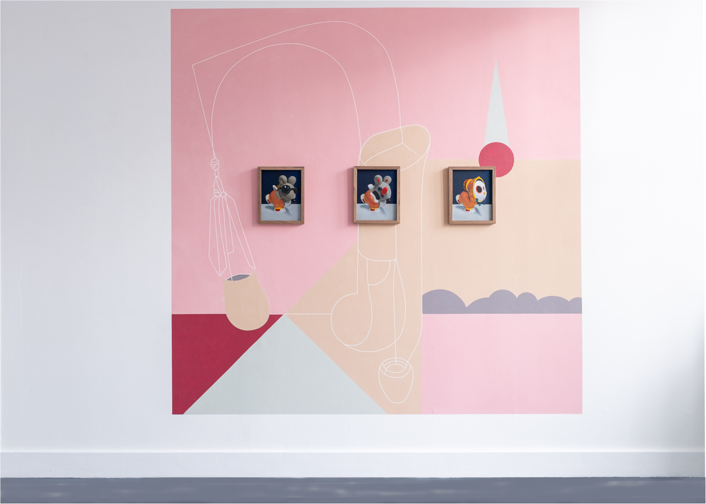 Wall art featuring three framed paintings image+text generated toy figurines on a pink and pastel geometric background with line art drawings.