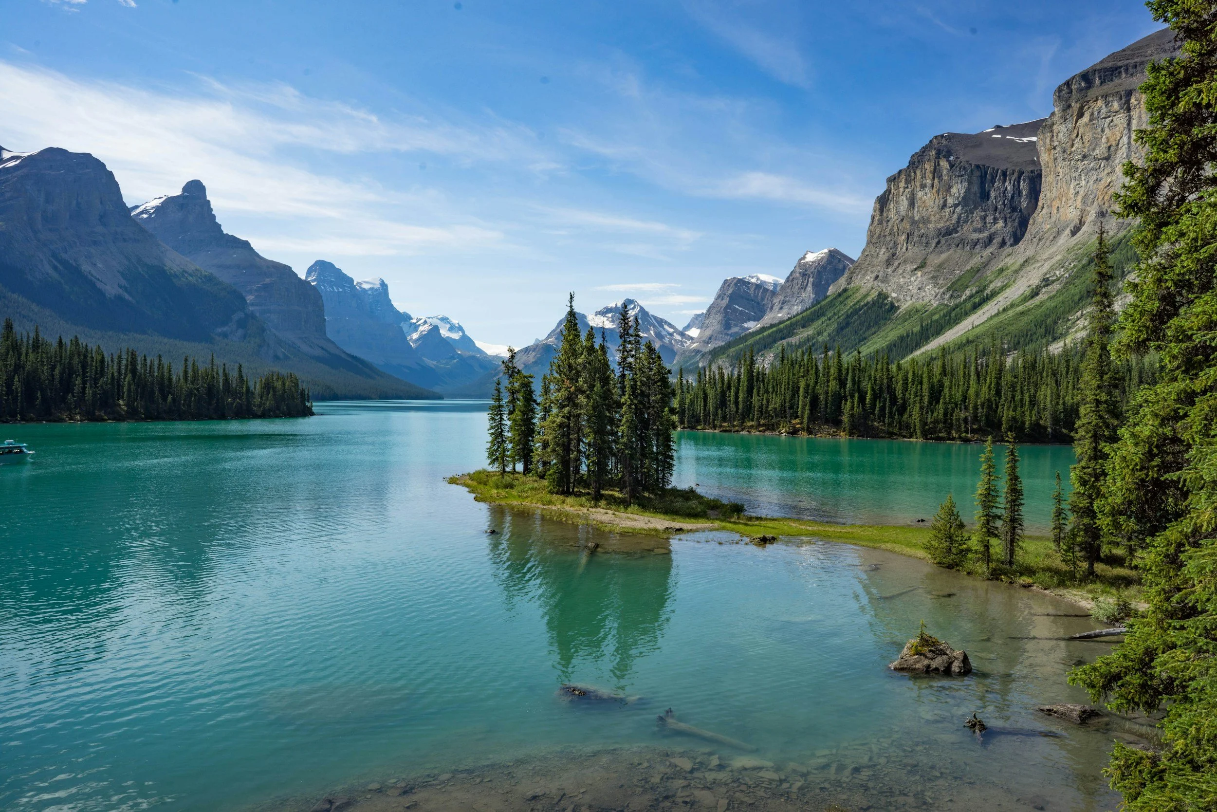 Snowy mountains reflecting on lake