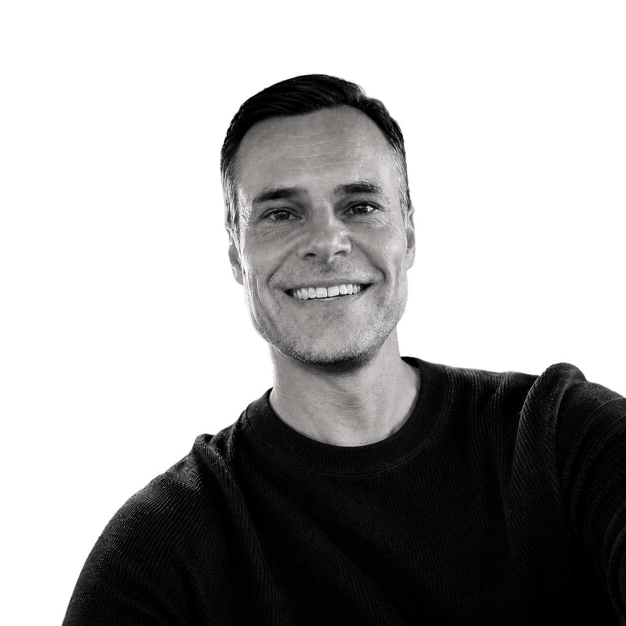 A black-and-white portrait of a smiling man in a black shirt, taking a selfie.