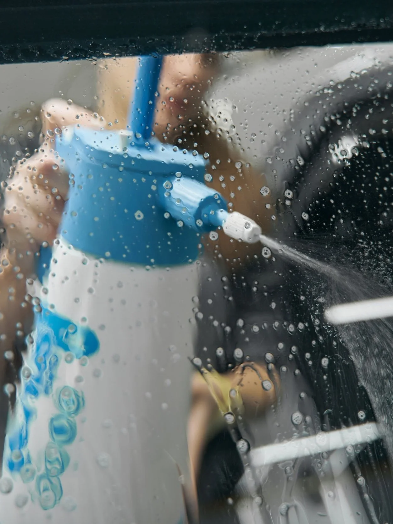 woman-applying-cleaning-solution-from-spray-bottle-2023-11-27-04-59-28-utc.jpg