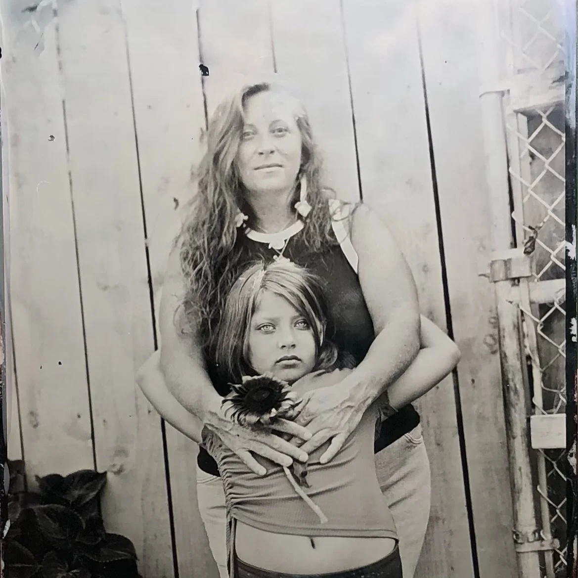 One of my favorites from this summer, Mary and her daughter with a sunflower 🌻 Made at the @falconfleamke on 8.31.25. 

#wetplatecollodion #tintype #ferrotype #tintypephotography #largeformatphotography #alternativeprocessphotography #naturallightti