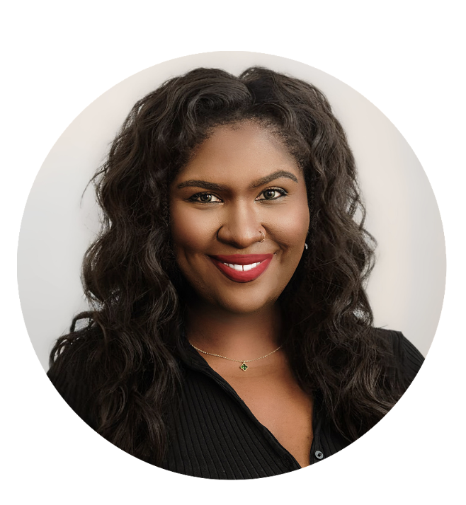 A woman with dark curly hair, red lipstick, and a black top smiling at the camera against a plain background.