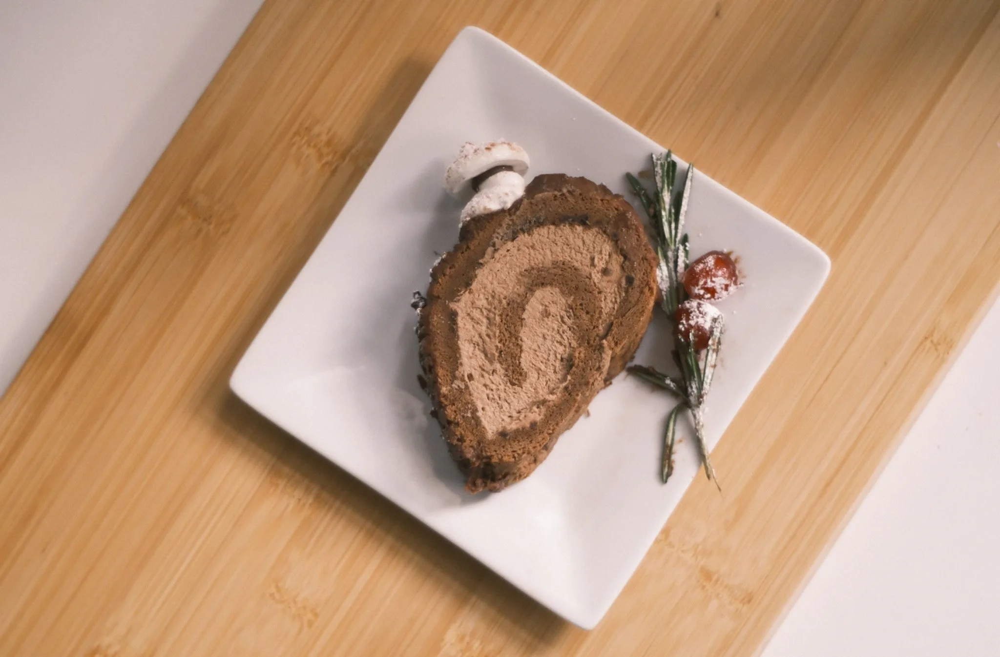Top view of a buche de noel slice on a cutting board