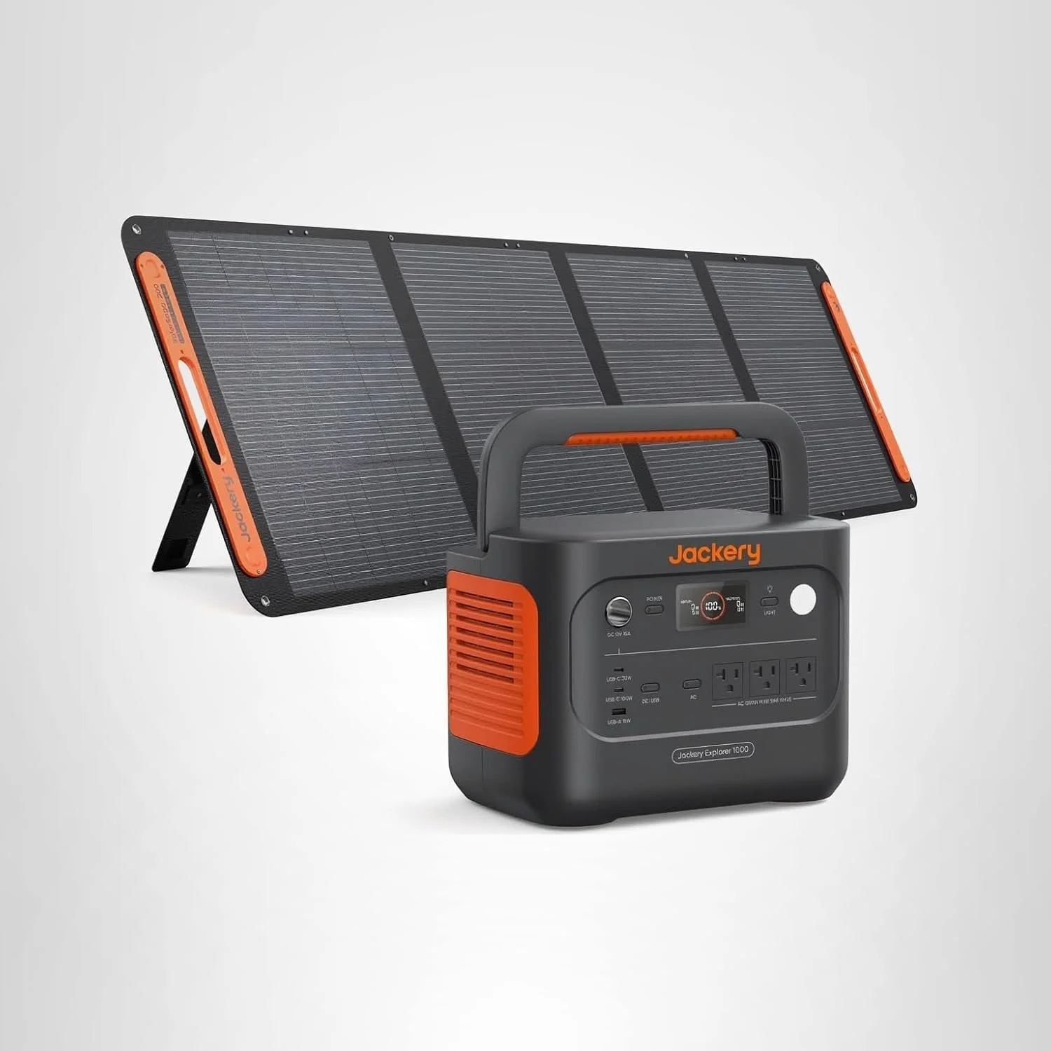 The Jackery solar generator with a solar panel in the background.