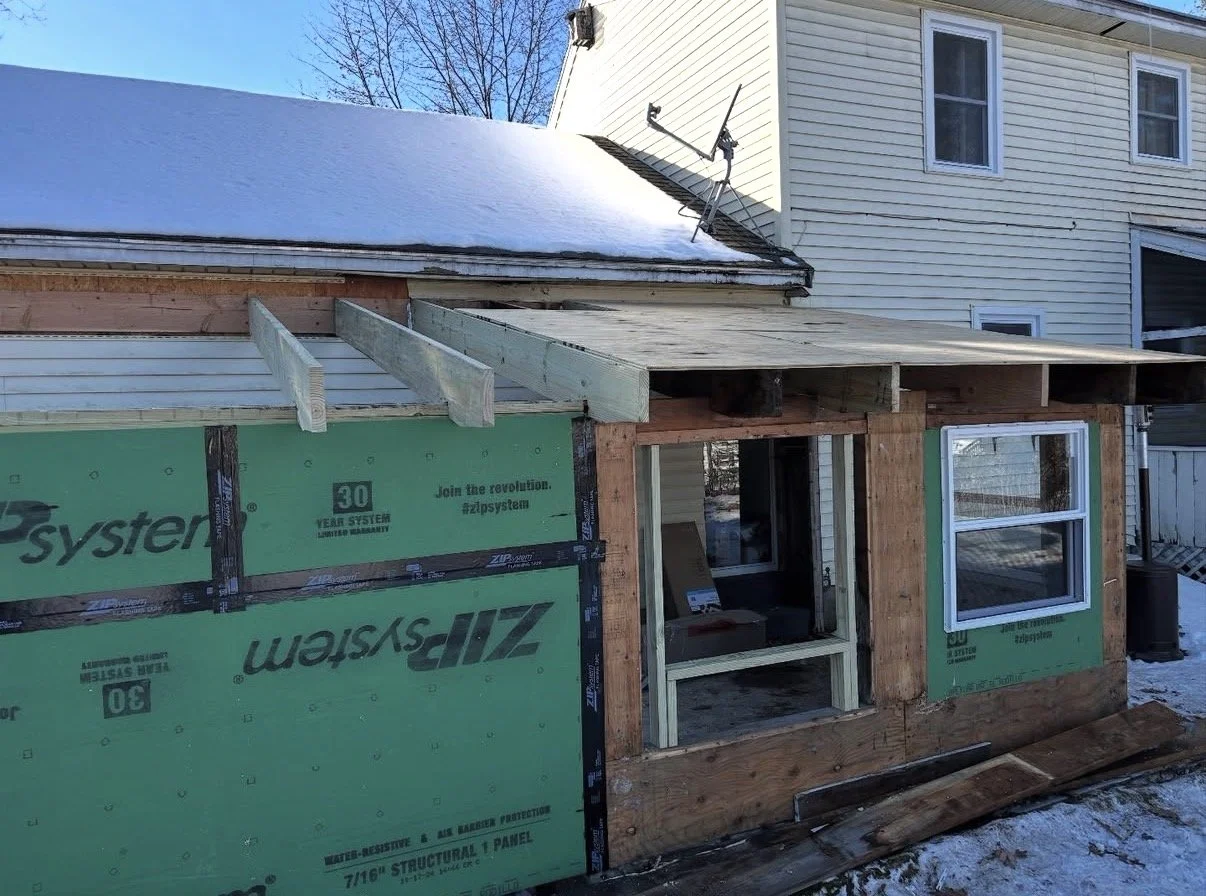 Framing and exterior remodel in progress for a home addition, including new roof structure and ZIP System sheathing installation by P Jordan Construction in New Hampshire