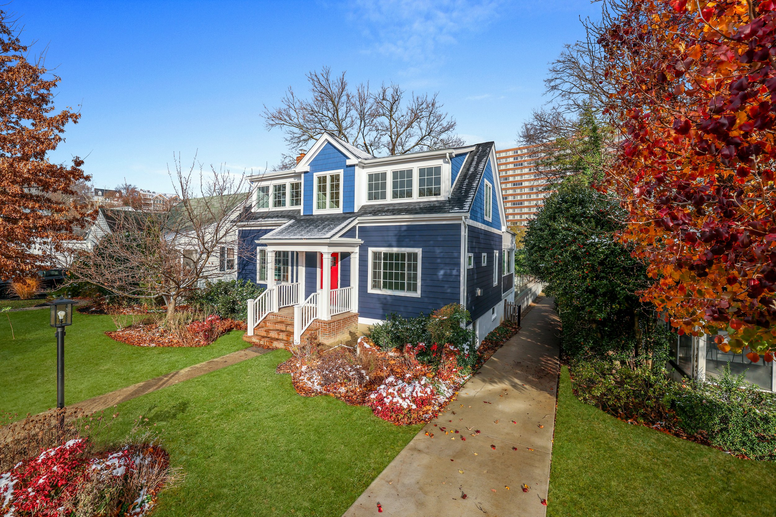 A blue two-story pop-top home renovation in Arlington, Virginia completed by G2 Builders.