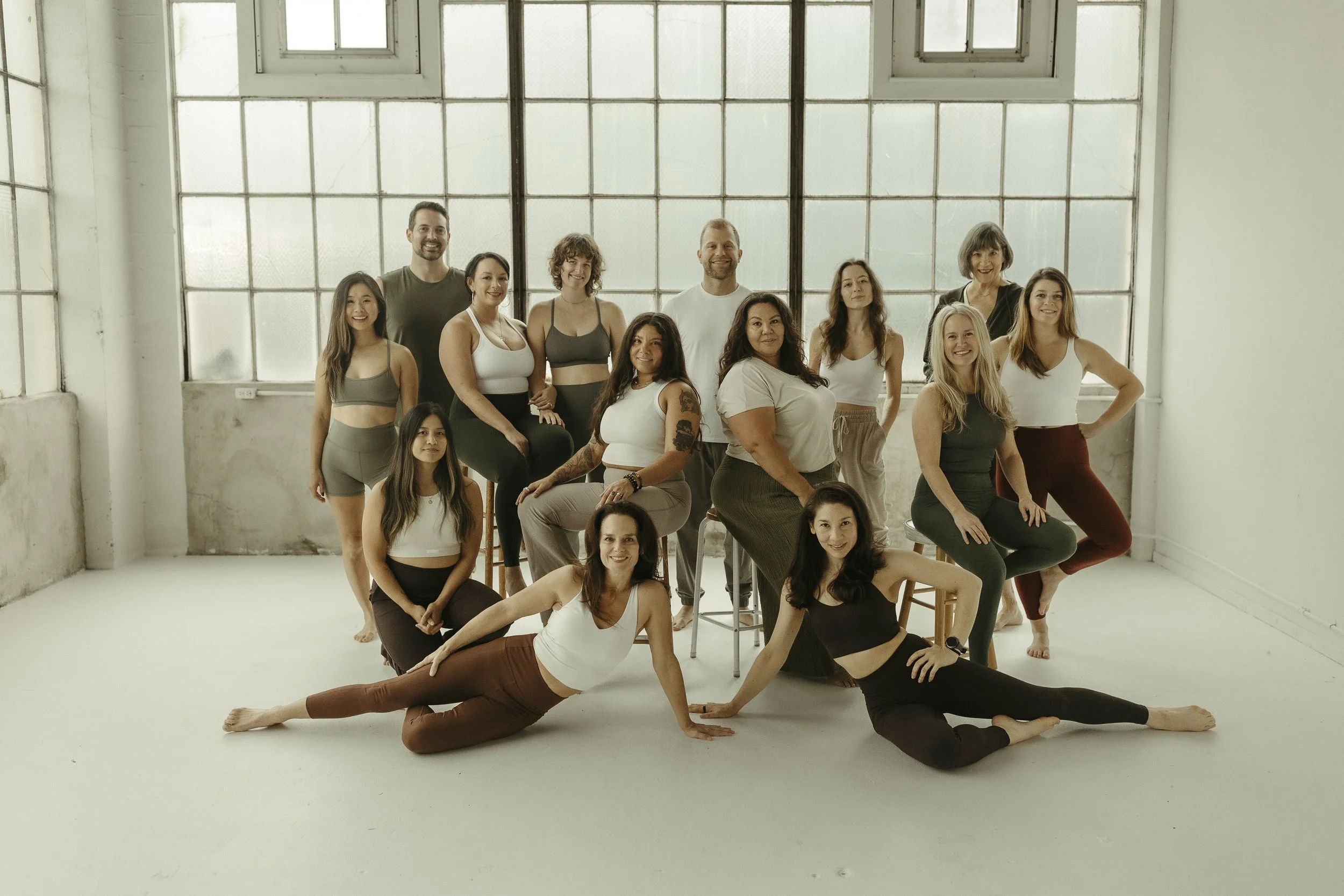 Reception desk with a smiling receptionist and a woman inquiring at the counter, decorated with a Buddha statue and shelves of products in the background.