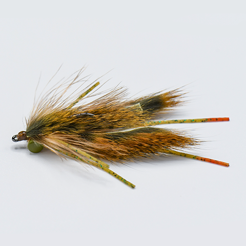 Close-up of a fishing fly with brown and beige feathers, used as bait in fishing