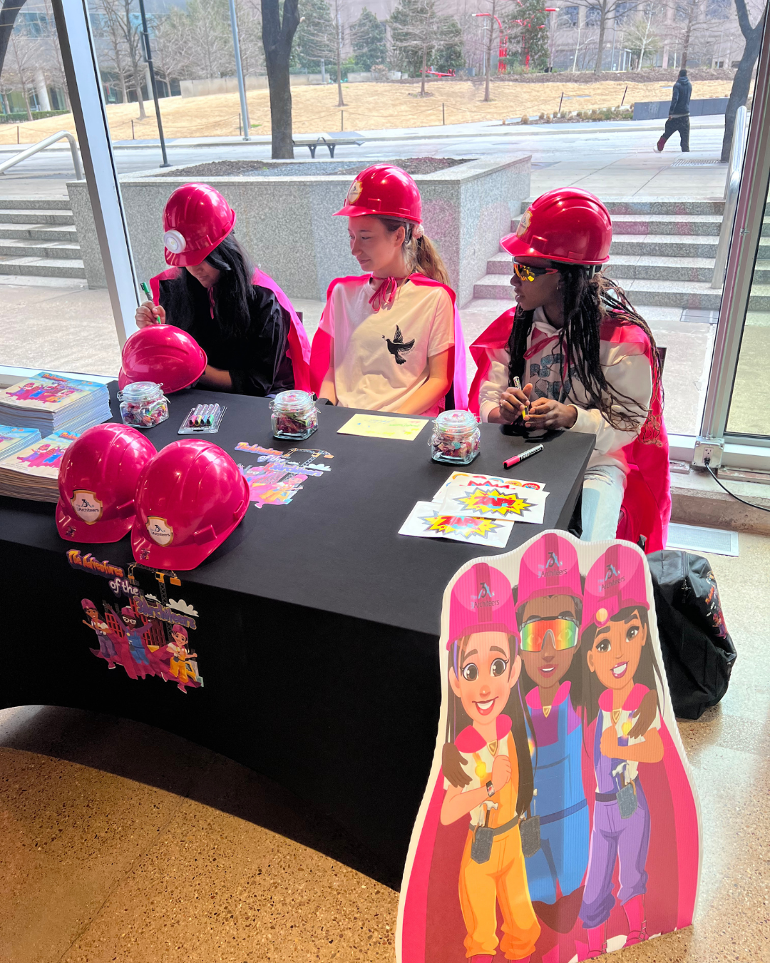 The Girls Signing Books.png
