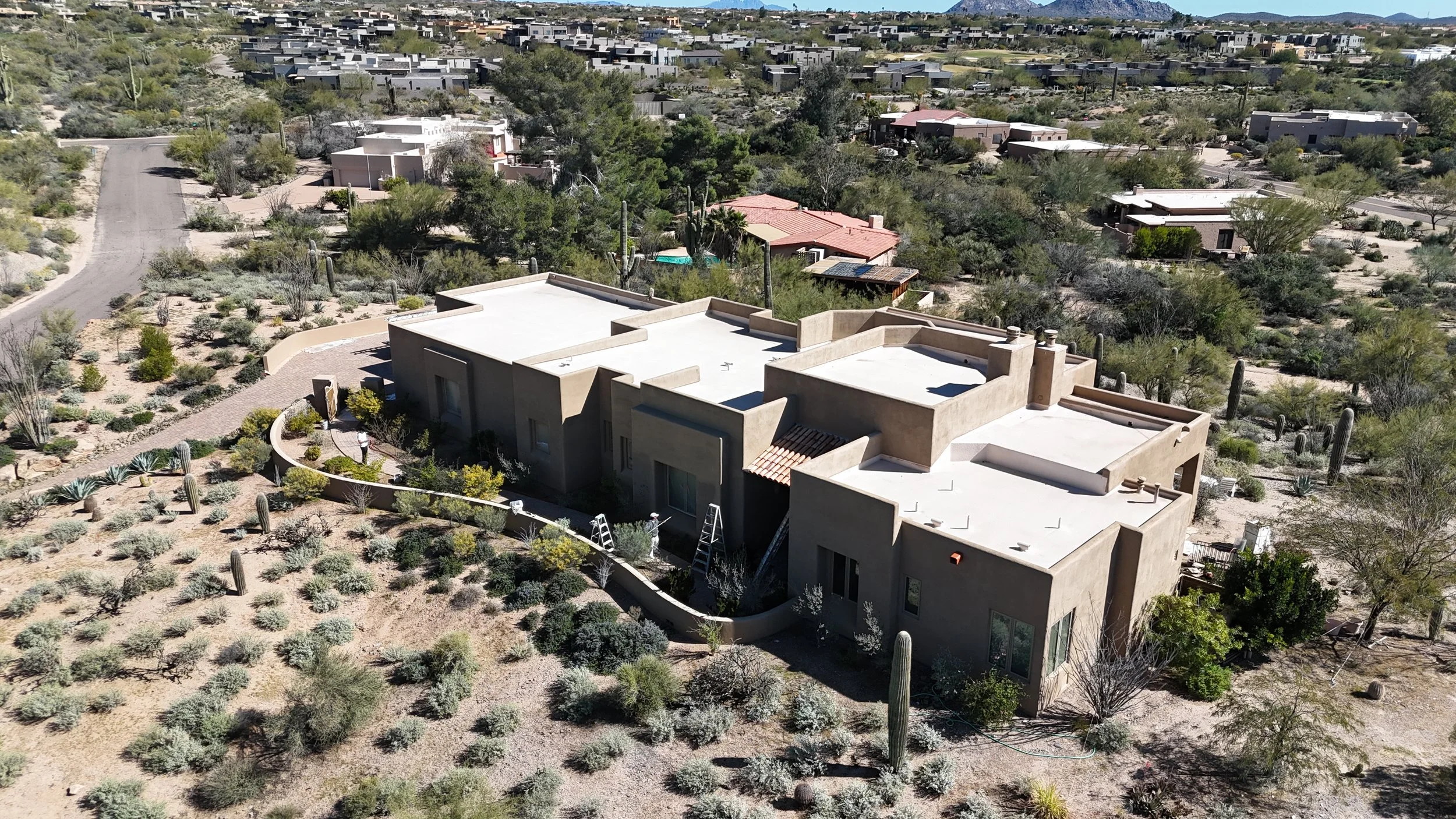 Drone view of exterior house painting project in Carefree, Arizona by James Painting Arizona showing a desert-style stucco home receiving professional exterior paint and preparation work.