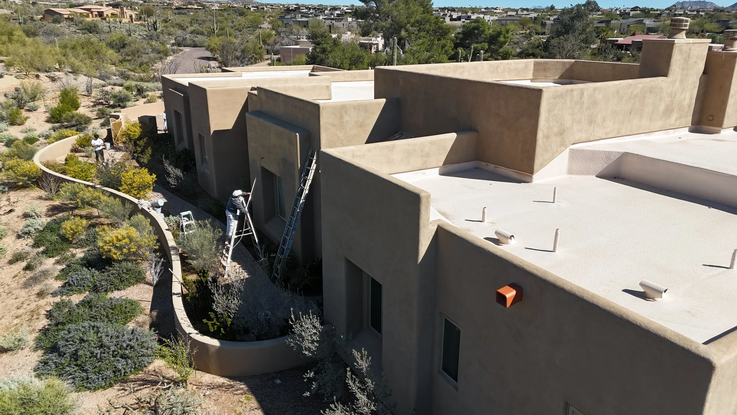 James Painting James and his crew performing exterior house painting and stucco repair on a  home in Carefree, Arizona. Drone view showing detailed preparation and professional painting work designed to protect the home from the Arizona sun.