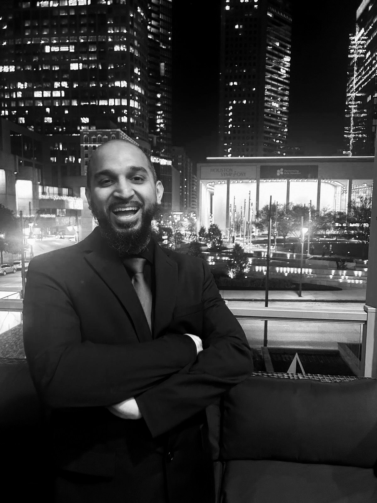 Abdurrehman Syed, founder of Brain Busters, standing in the city and smiling