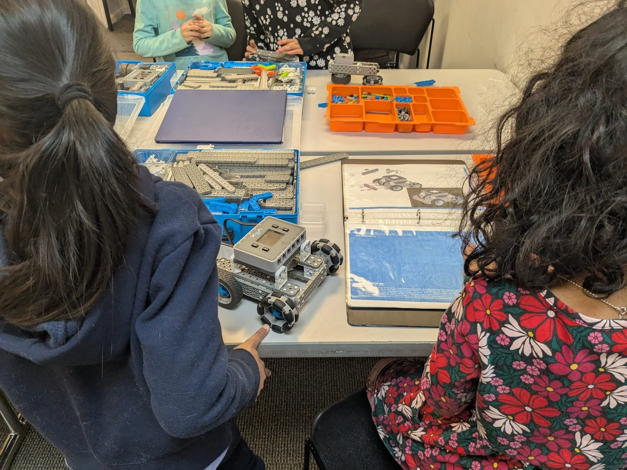 Students building and coding robots in a Brain Busters robotics class in Chicago