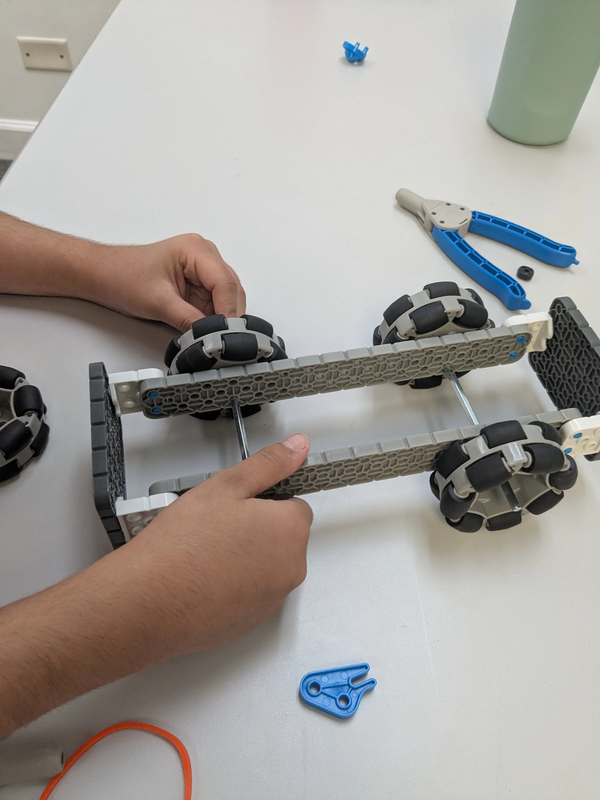 Student building a rubber band powered car during a Brain Busters engineering class