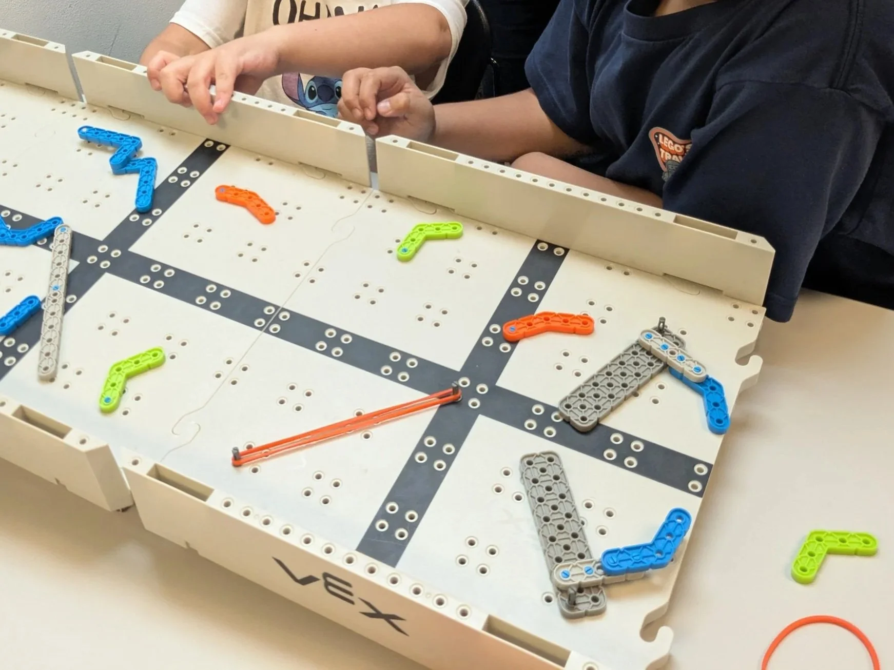 Student building a human-height pinball game as part of a Brain Busters engineering project