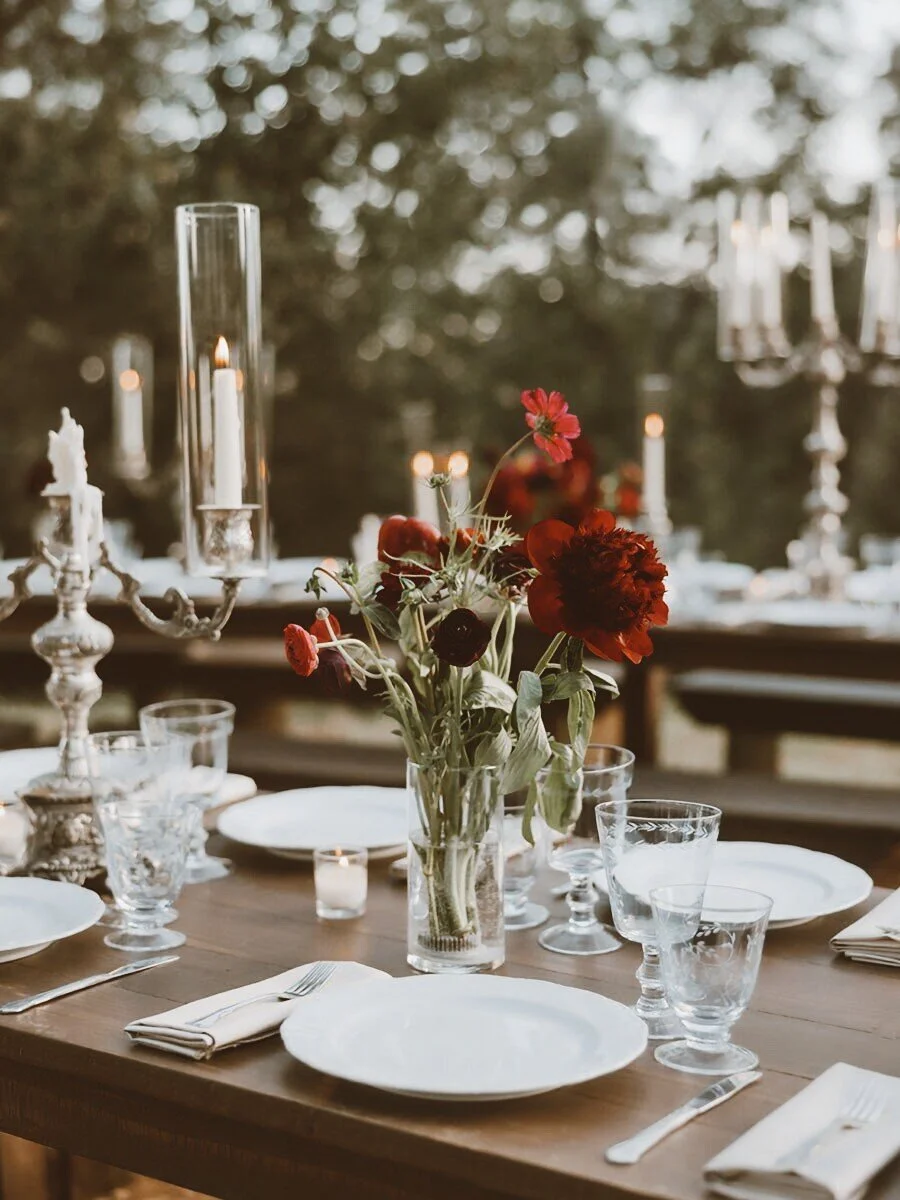 Wedding dinner table settings with fresh floral arrangements and candlelight