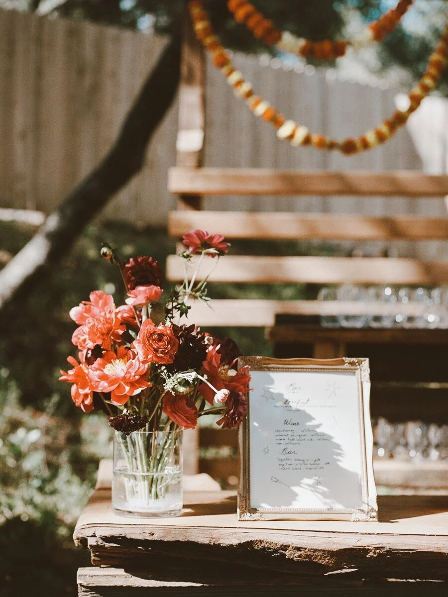 Wedding decor floral arrangement and bar menu