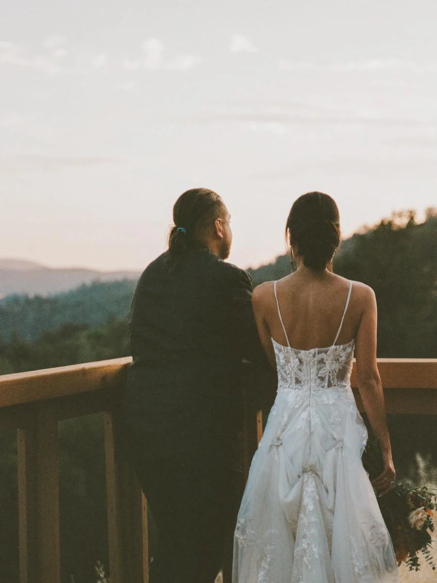 Bride and Groom looking out at scenic valley vista view at Deloro Valley
