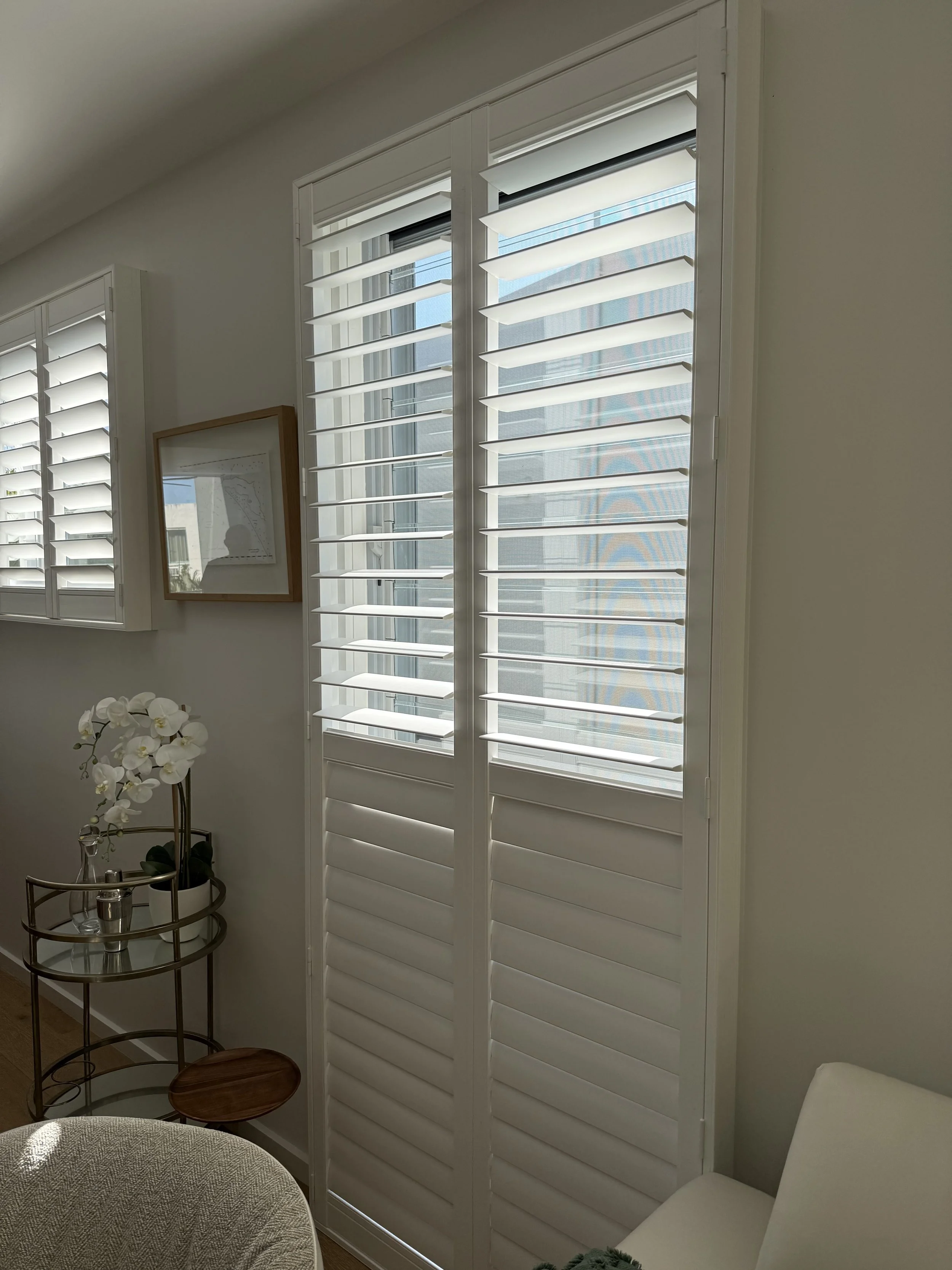 modern plantation shutters with adjustable slats for light control and privacy in Griffith