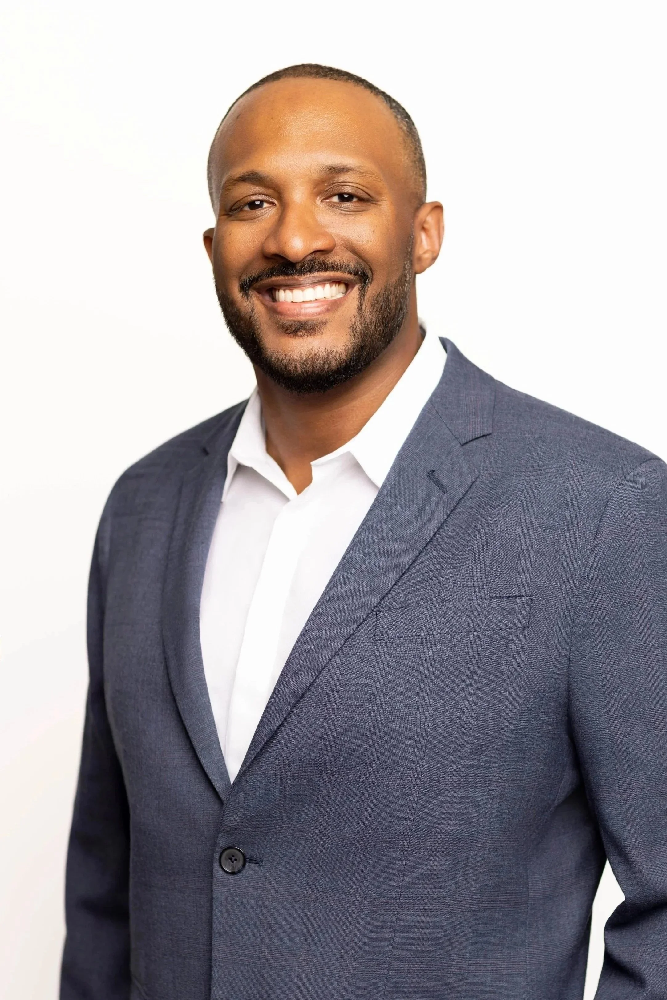 Corporate headshot of a professional man photographed on location at a conference using a mobile lighting and backdrop setup