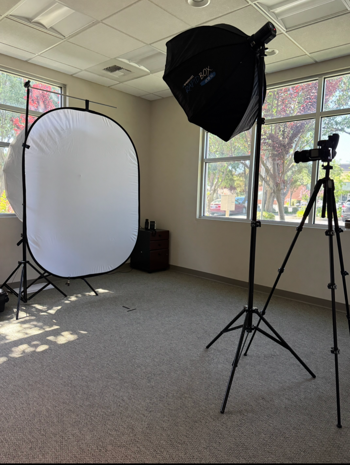 On-location corporate headshot station with professional lighting and backdrop set up at a conference in San Diego