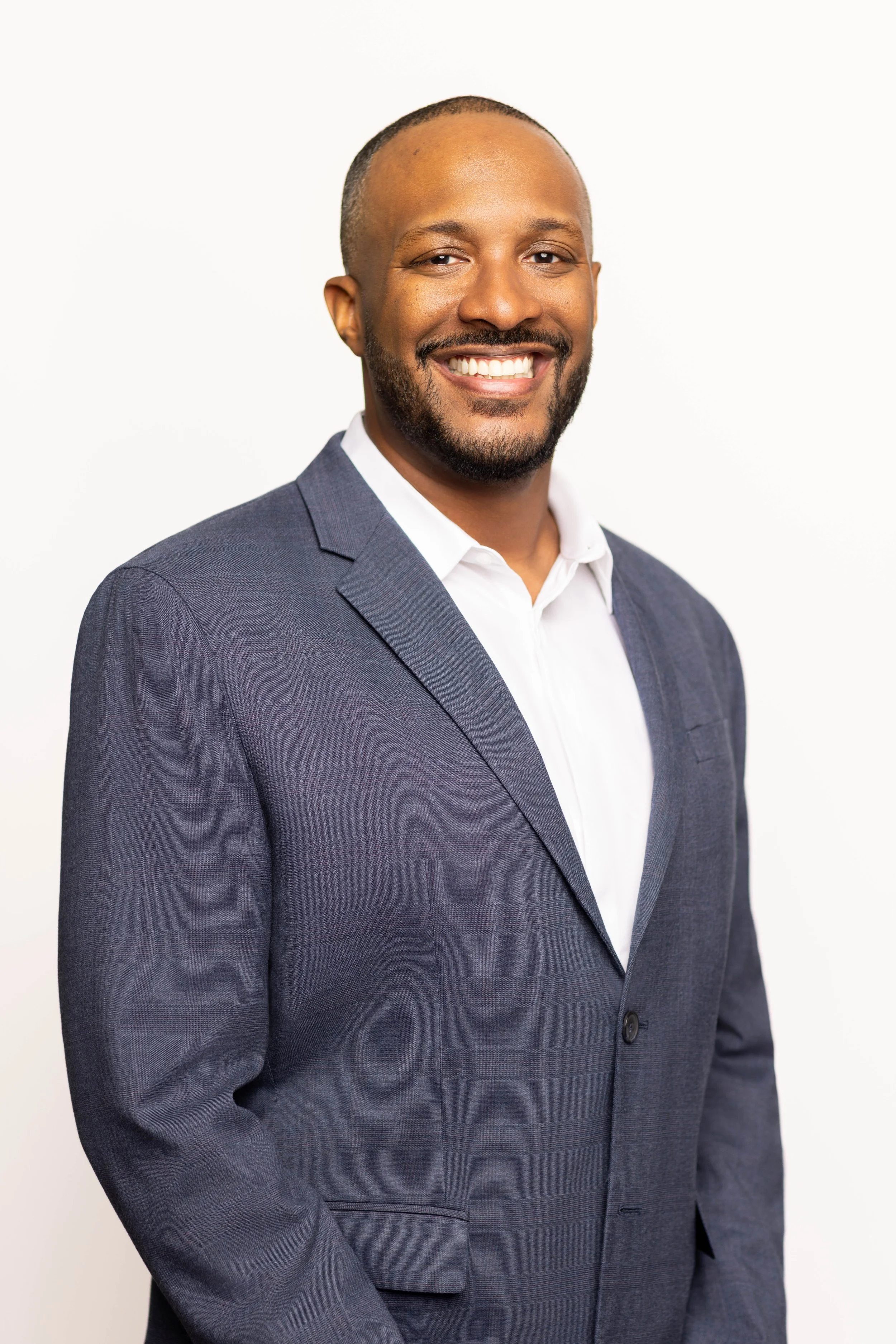Professional business headshot of a man in San Diego, photographed in a clean, modern studio style