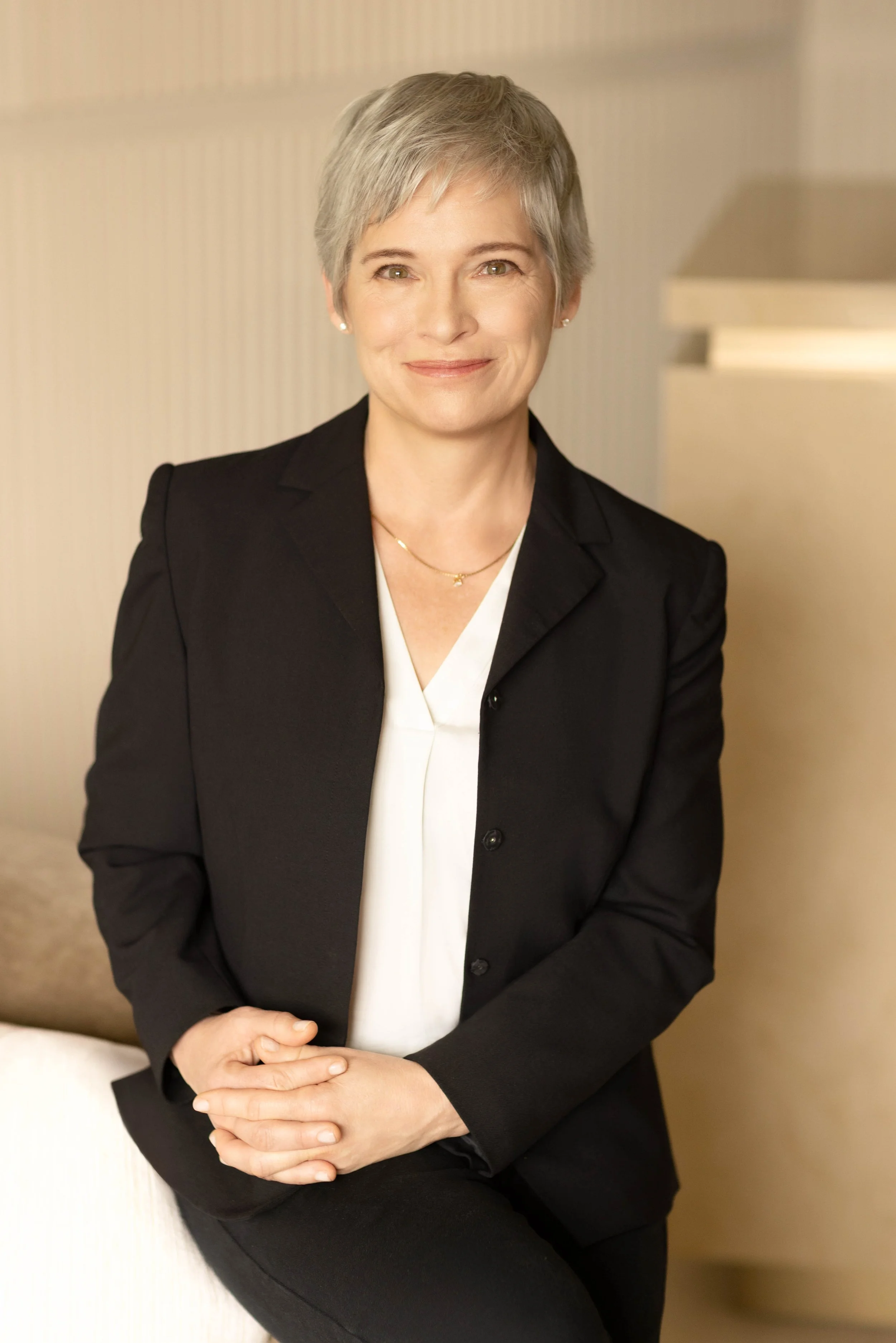 Executive corporate headshot of a professional woman photographed on location with clean, modern lighting