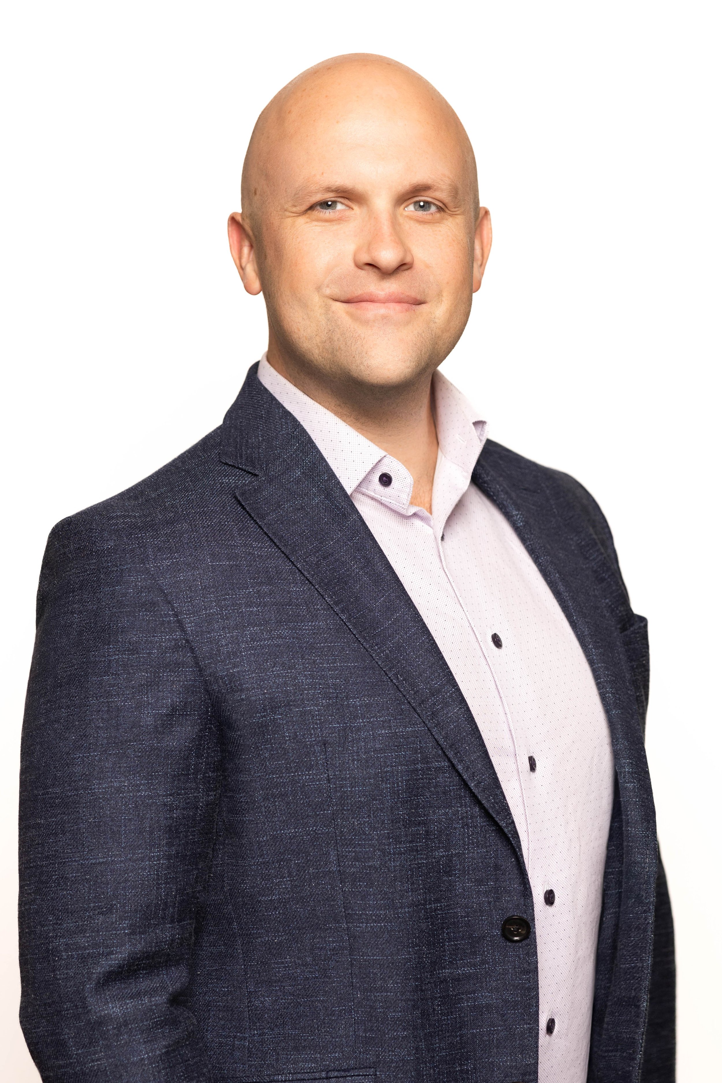 Executive corporate headshot photographed on site using a mobile conference headshot station with professional lighting