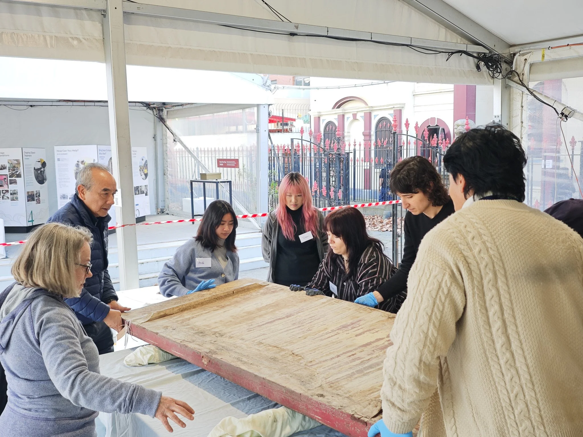  See Yup Society President Michael Lam working with volunteers to safely move a large temple plaque. Photo: Danni Lin 
