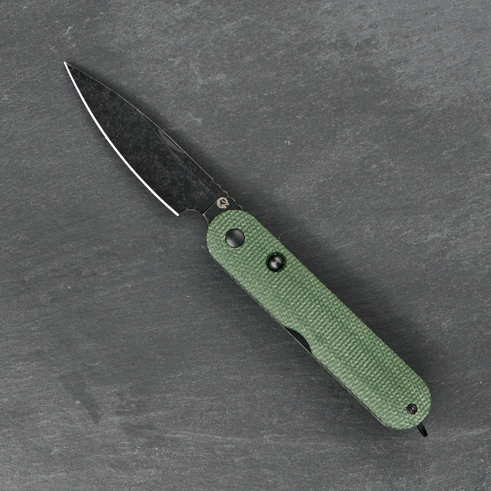 Rapax Kiki with a spear point blade and green handle, shown open.