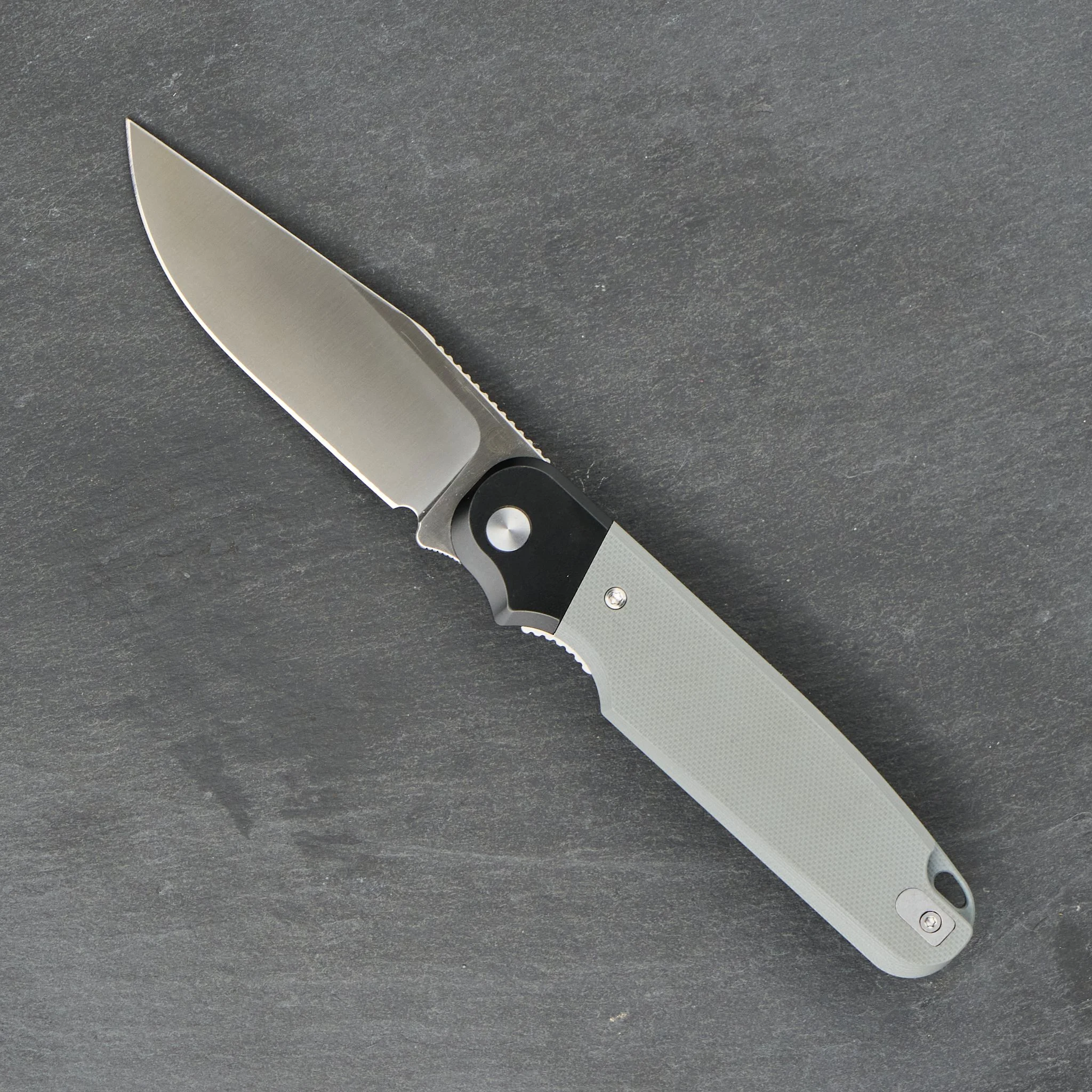 Rapax Buddy with a gray handle, shown open with its finger choil visible.